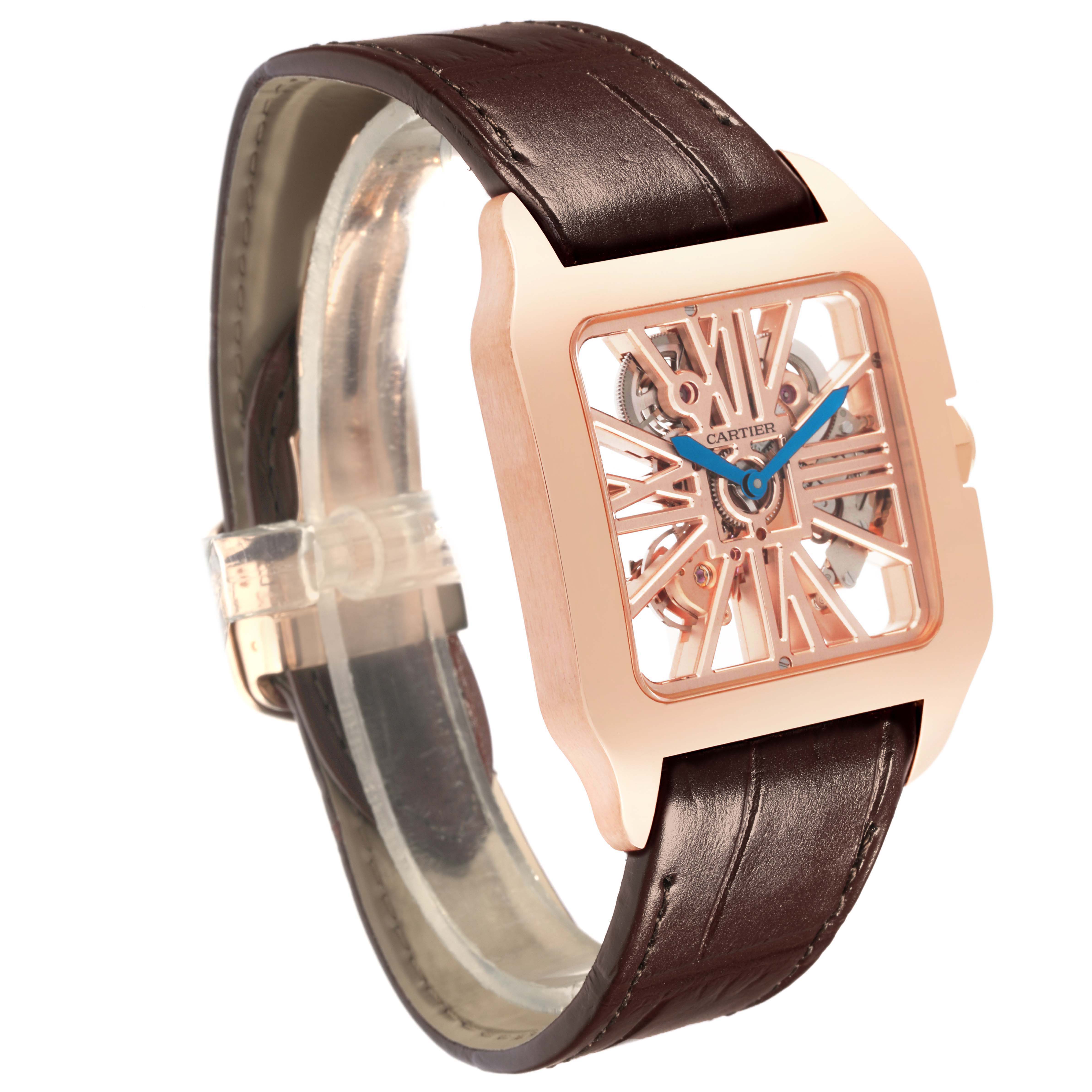 The Cartier Santos W2020057 Men's Rose Gold Transparent Dial watch is angled to show the skeleton dial, rose gold case, and brown leather strap.