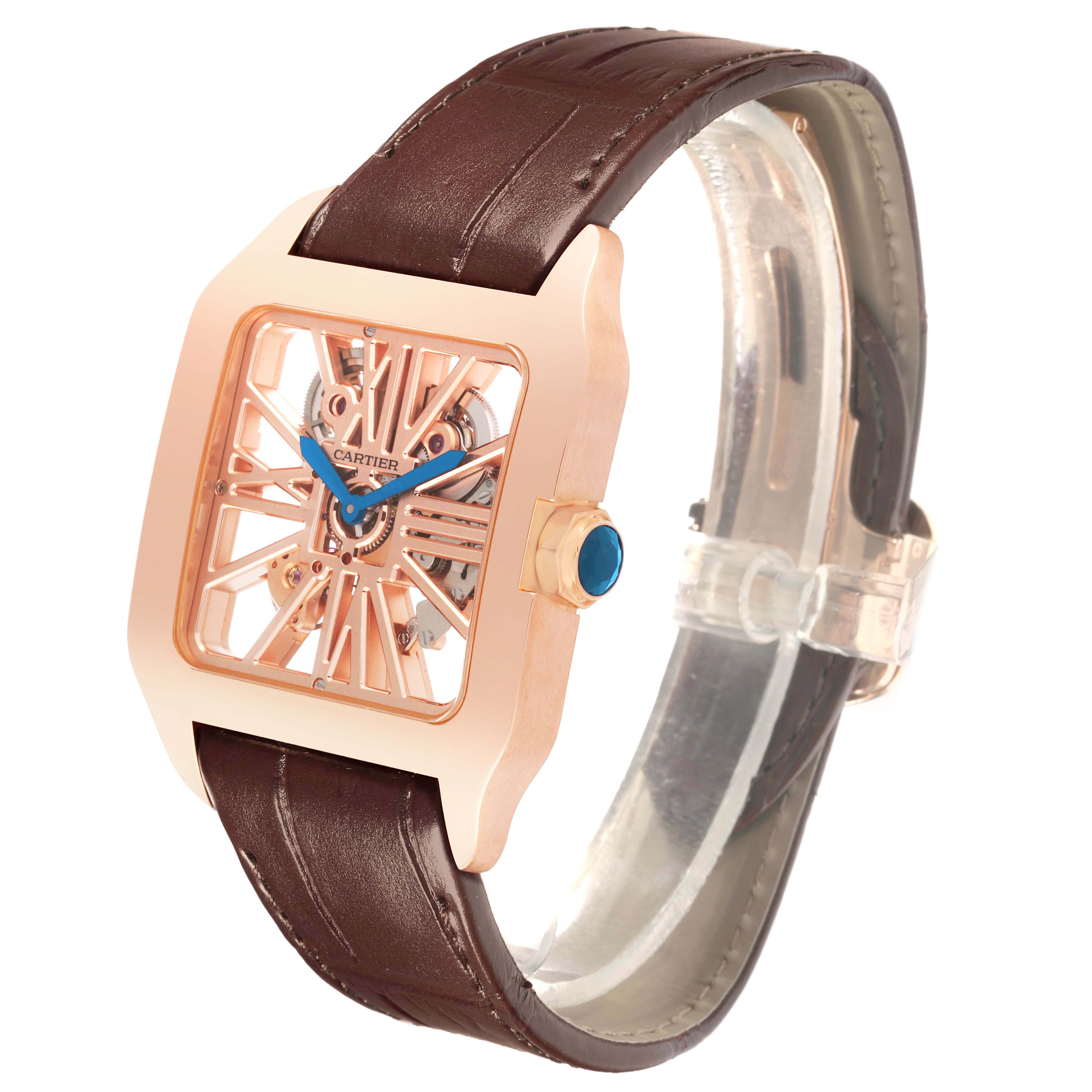 The Cartier Santos 65759 Men's Rose Gold Transparent Dial 65759 Men's Rose Gold Transparent Dial watch is shown from a side angle, displaying its brown strap, rose gold case, and skeleton dial.