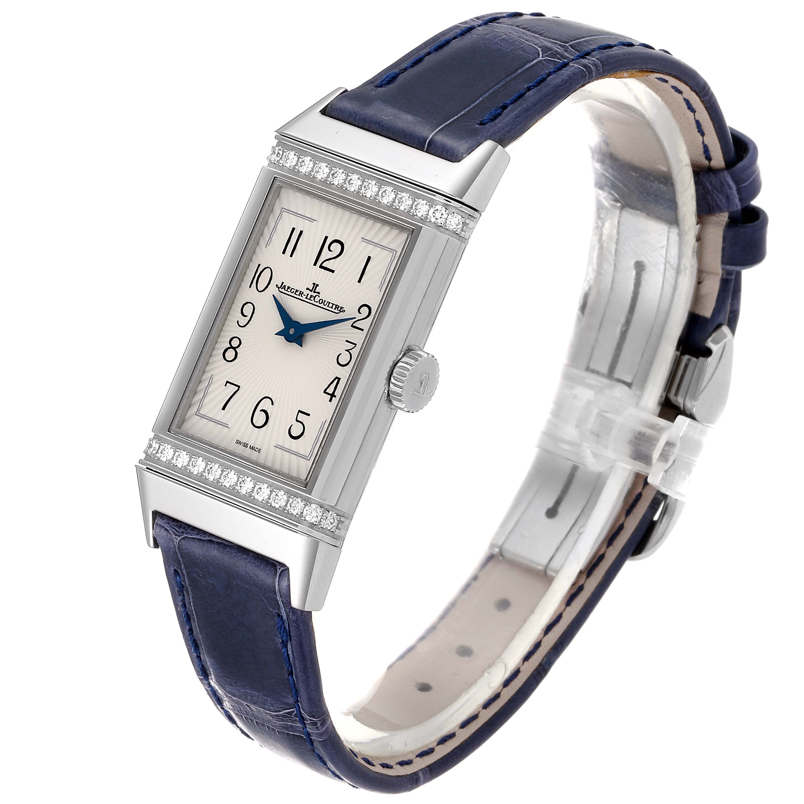 The image shows a Jaeger-LeCoultre Reverso watch from a slight angle, highlighting the dial, case, crown, and strap.