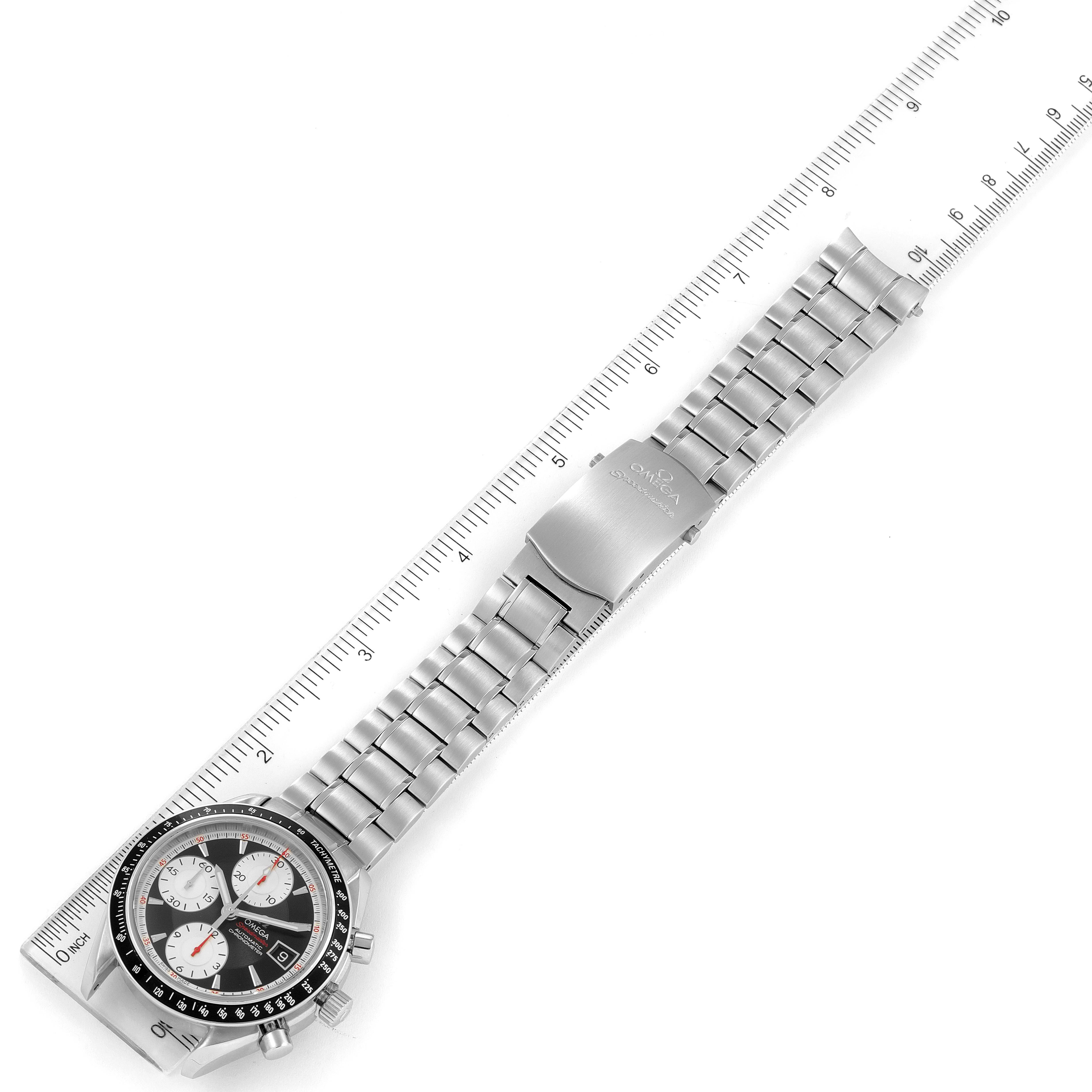 The image shows an Omega Speedmaster 3210.51.00 Men
s Stainless Steel Black Dial 3210.51.00 Men
s Stainless Steel Black Dial watch with a metal bracelet and clasp, placed alongside a measuring ruler for scale.