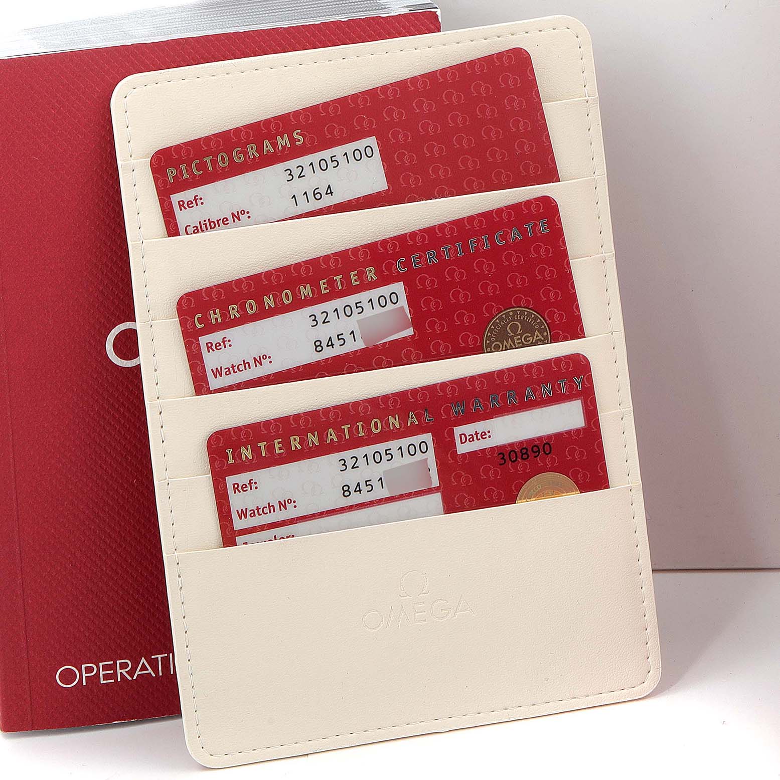 The image shows Best Quality
ity and warranty cards for the Omega Speedmaster 3210.51.00 Men
s Stainless Steel Black Dial 3210.51.00 Men
s Stainless Steel Black Dial model, organized in a white cardholder.