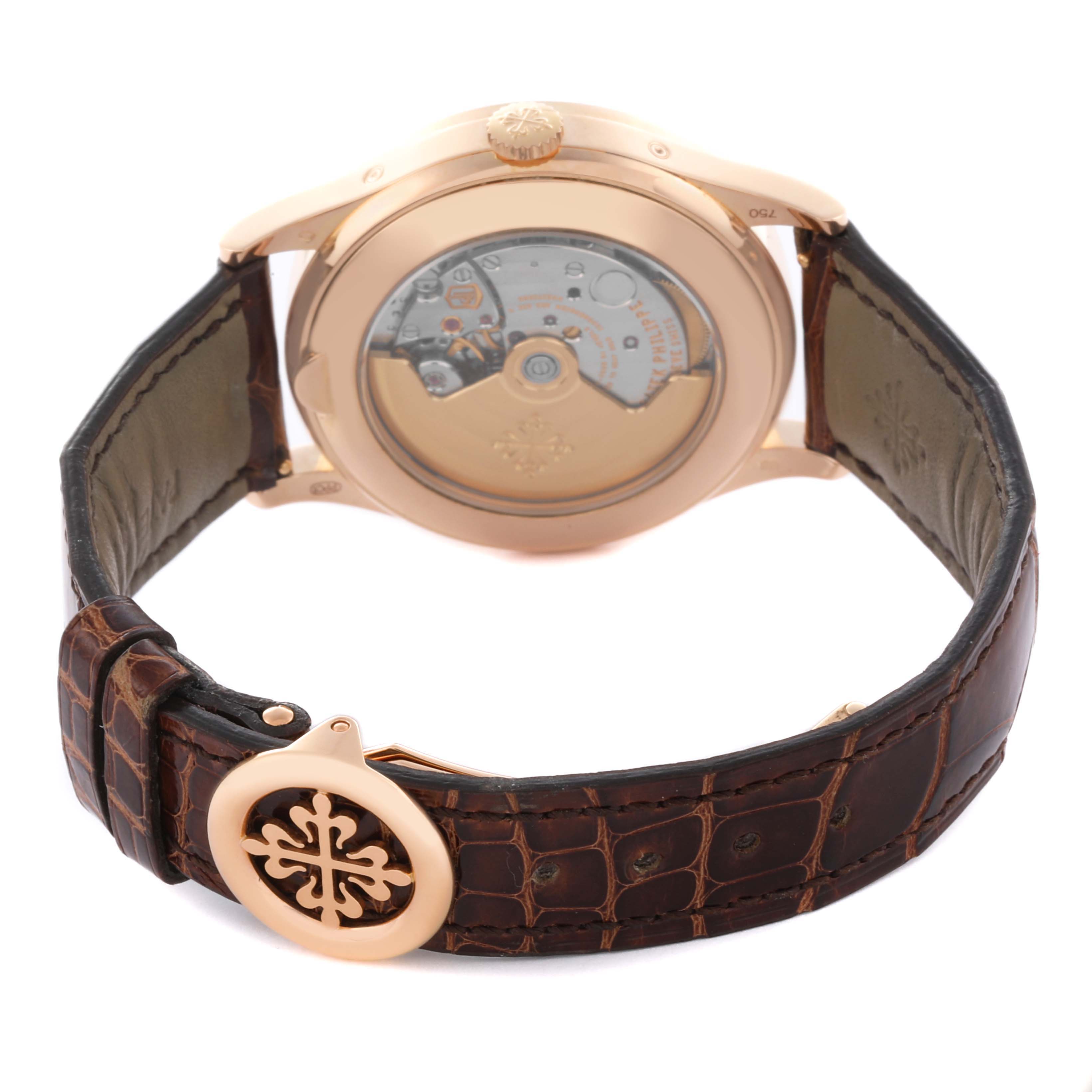 The image shows the back view of the Patek Philippe Complications 5396R-011 Men
s Rose Gold Silver Dial 5396R-011 Men
s Rose Gold Silver Dial watch, featuring its transparent case back and leather strap.