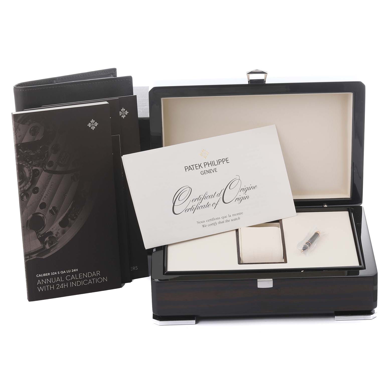 The image shows a Patek Philippe Complications 5396R-011 Men
s Rose Gold Silver Dial 5396R-011 Men
s Rose Gold Silver Dial watch box, certificate, booklet, and a small tool.