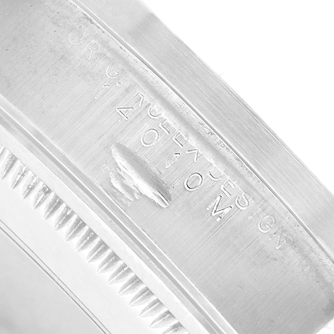 The image shows a close-up of the engraved edge of a Rolex Air-King 14010 Men's Stainless Steel Silver Dial watch case, displaying the serial number and part of the bezel.
