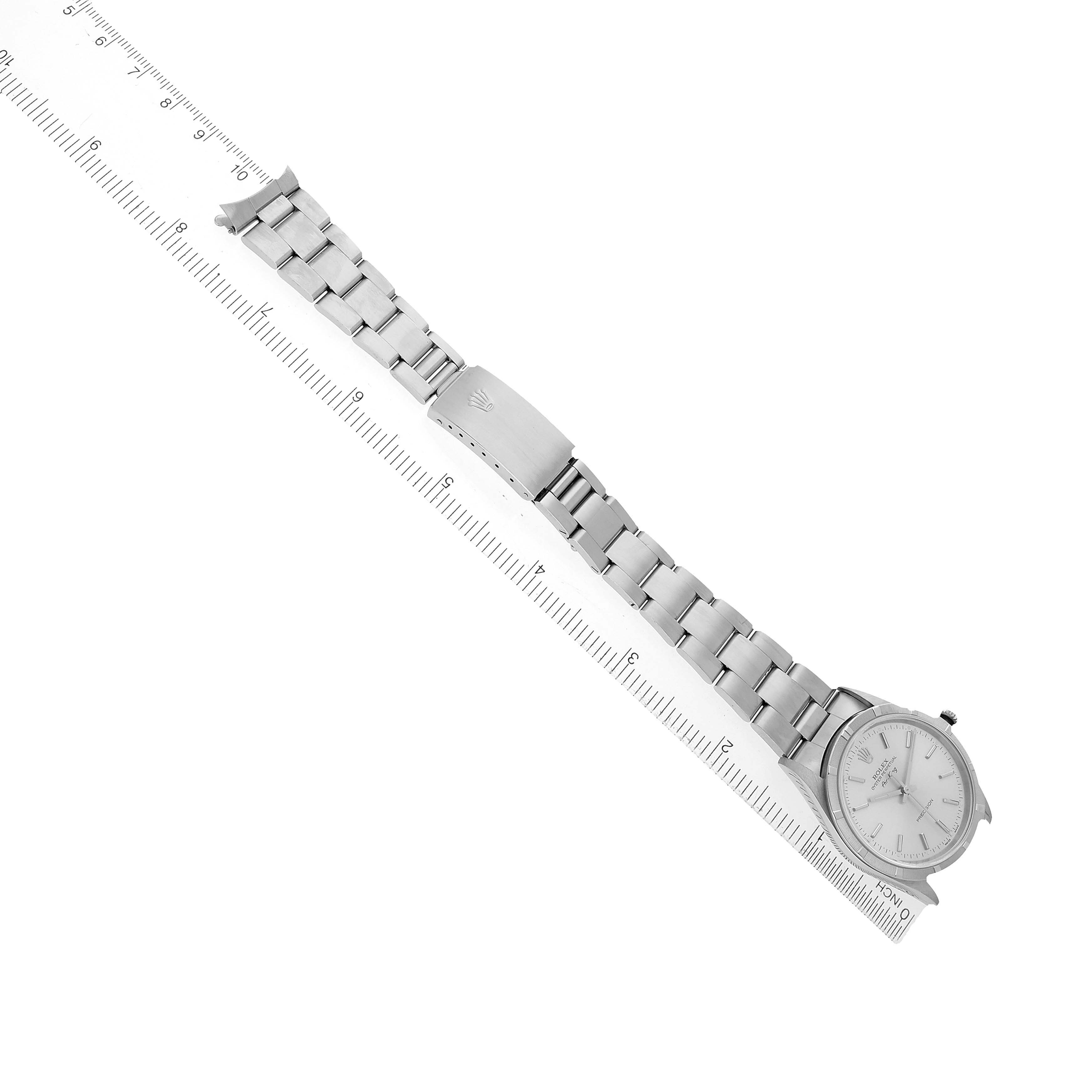 The Rolex Air-King 14010 Men's Stainless Steel Silver Dial watch is shown from a top view, displaying the full bracelet and face alongside a ruler for scale.