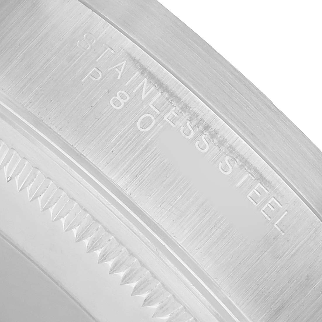 The image shows a close-up of the case back edge of a Rolex Air-King 14010 Men's Stainless Steel Silver Dial, highlighting the "STAINLESS STEEL" engraving.