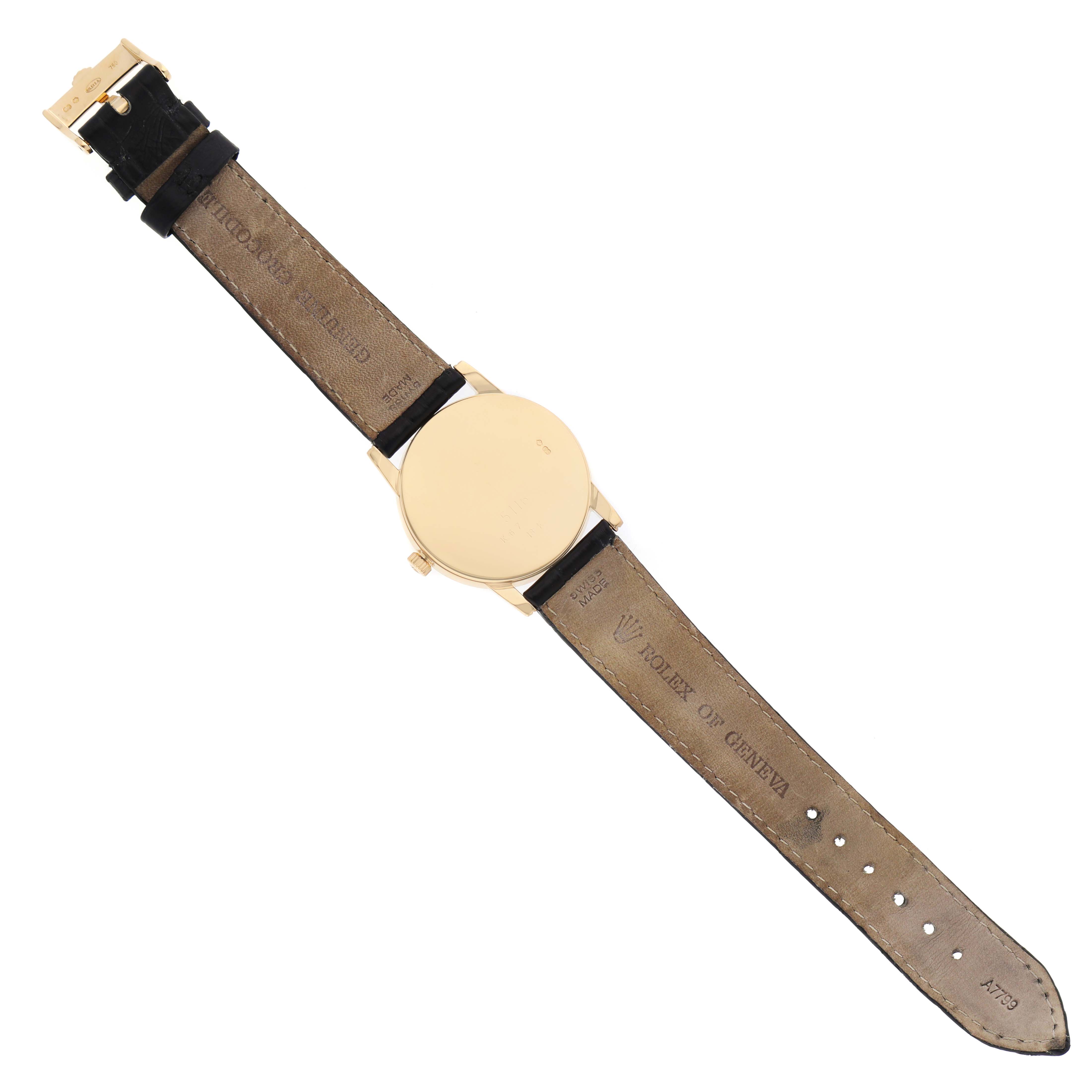 The Rolex Cellini 5116/8 Men's Yellow Gold White Dial watch is shown from the back, displaying the strap and buckle.