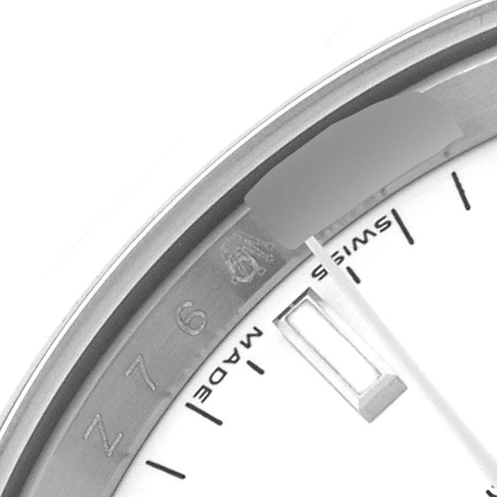 The image shows a partial close-up of the Date model watch by Rolex, focusing on the dial edge and part of the inner bezel.