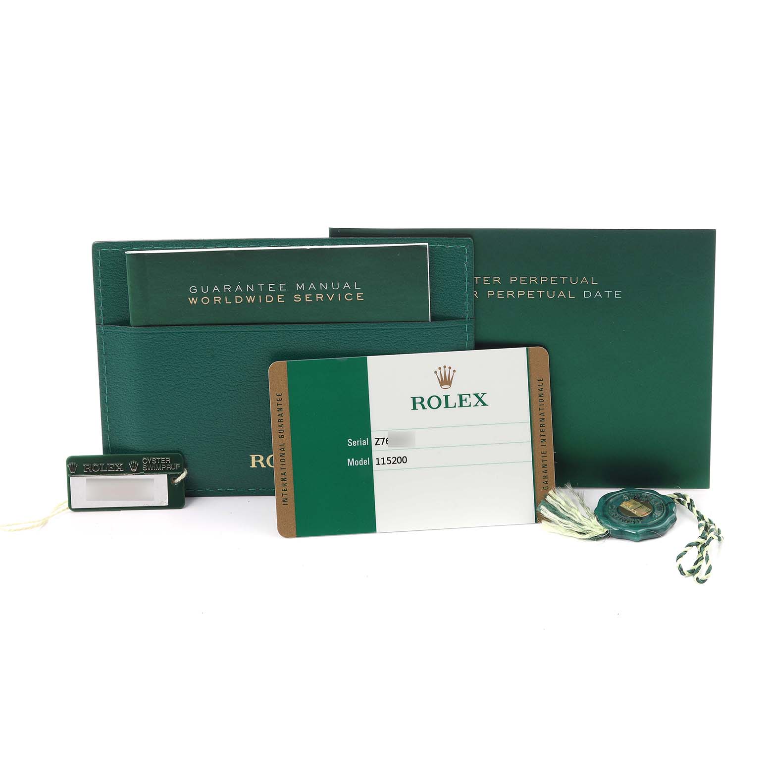 The image shows watch accessories for a Rolex Date 115200 Men's Stainless Steel White Dial 115200 Men's Stainless Steel White Dial model, including booklets, a warranty card, and tags.