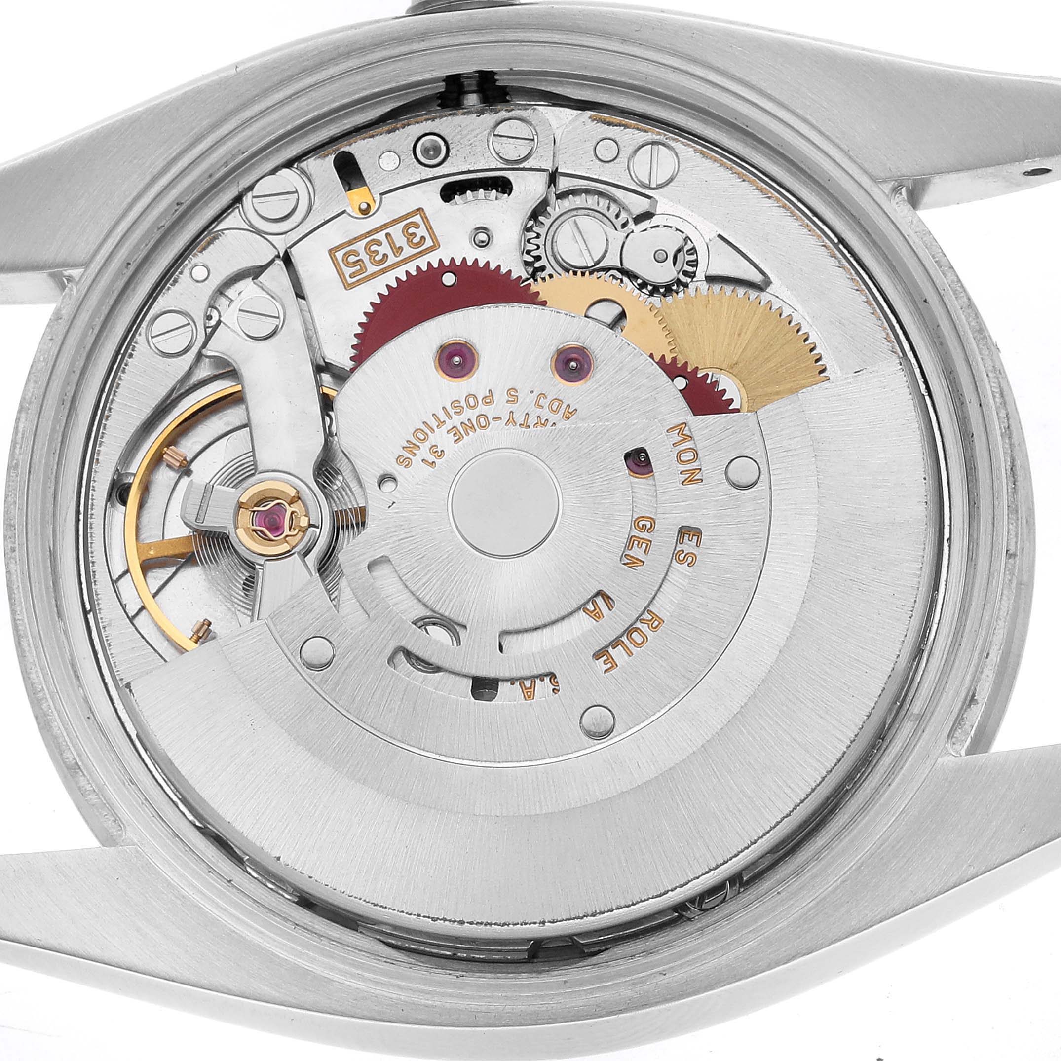 The image shows the movement of a Rolex Date 115210 Men's Stainless Steel White Dial model from the back, highlighting gears, rotors, and intricate mechanical parts.
