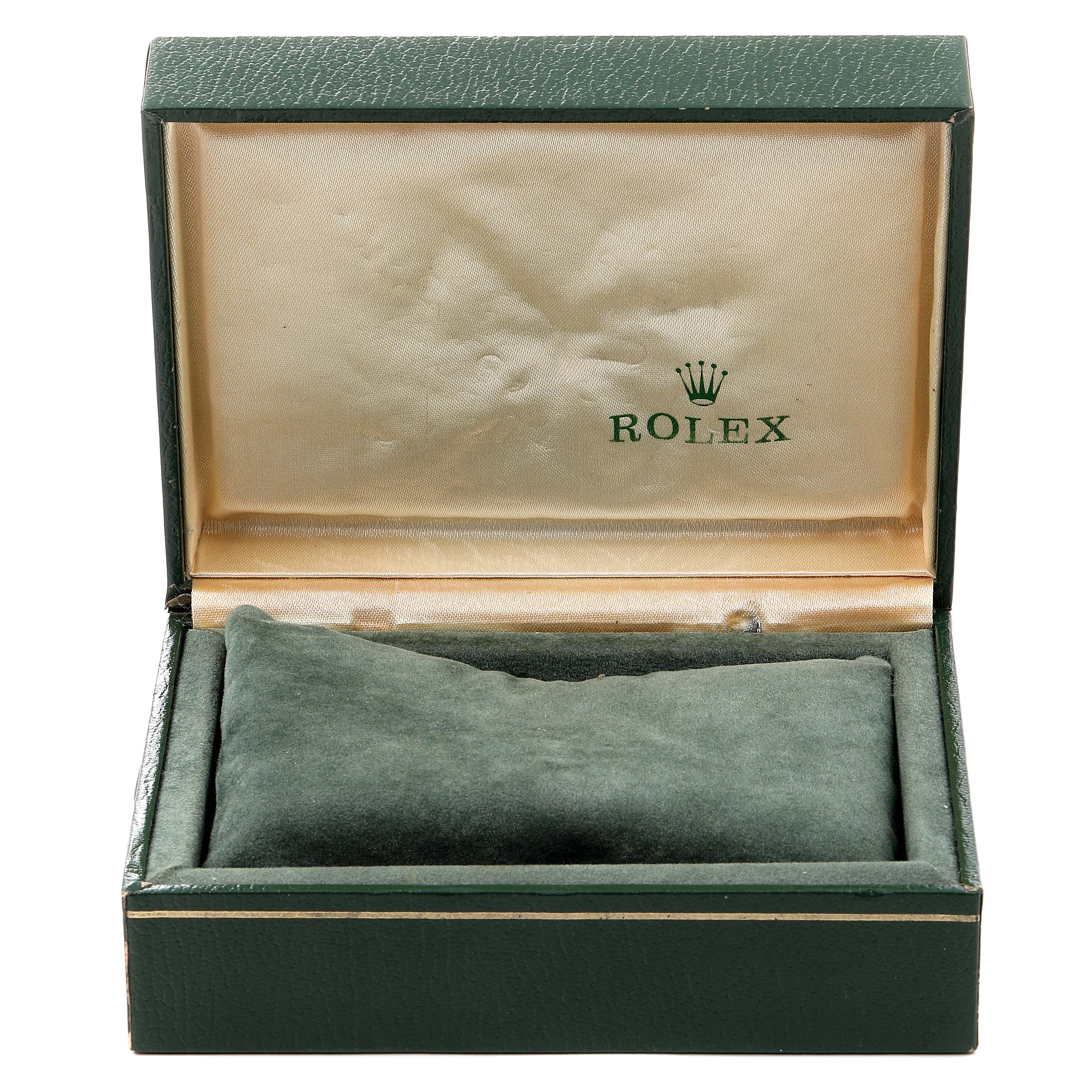 The image shows an open Rolex watch box for the Datejust model, with the brand logo on the interior lid.