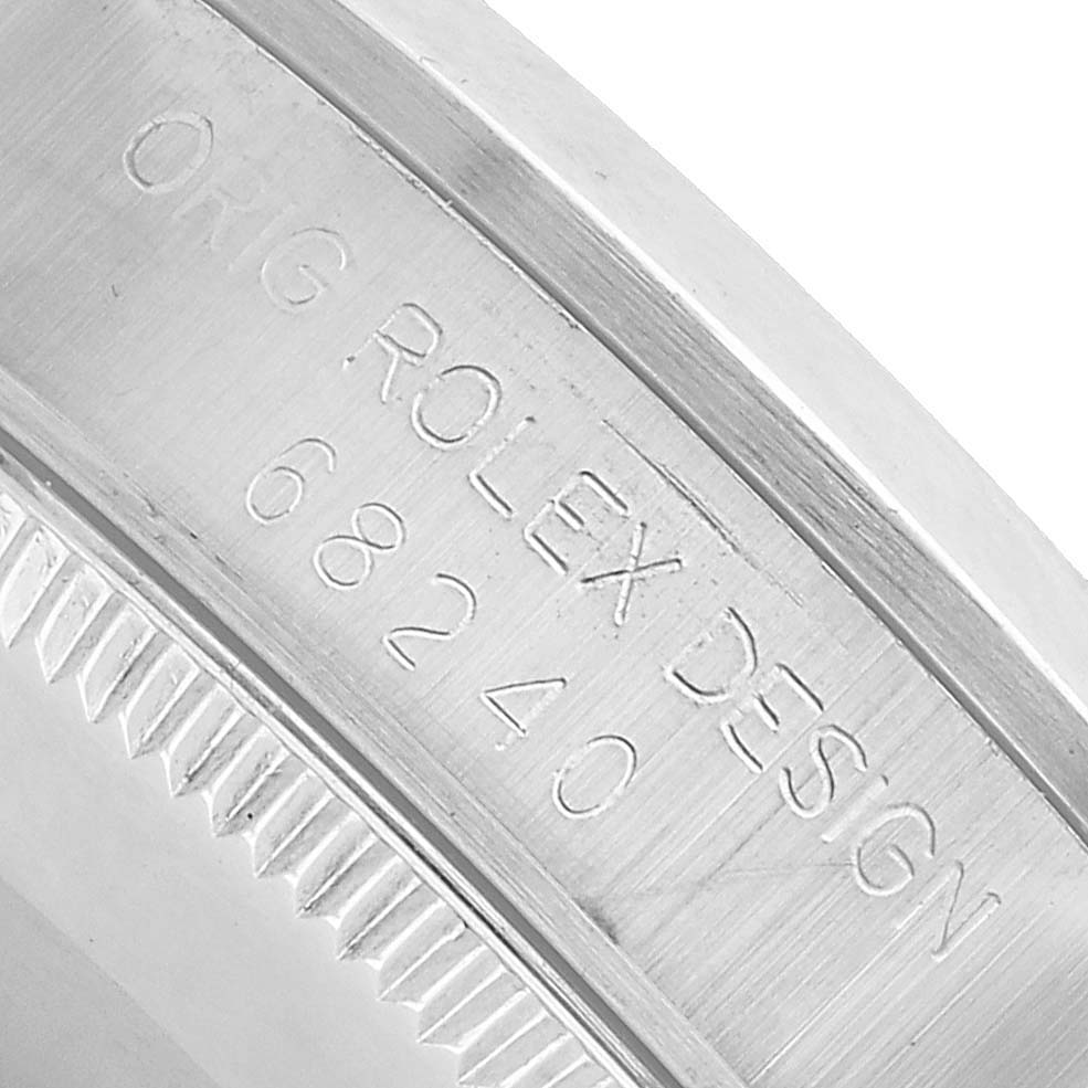 The image shows a close-up of the Rolex Datejust 68240 Women's Stainless Steel Pink Dial's bezel and engraved case side with the design number.