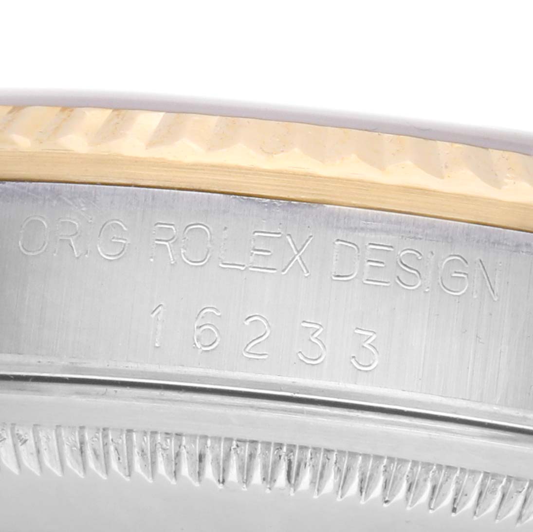 The image shows a close-up of the case edge and engraved serial number of a Rolex Datejust 16233 Men's Steel and Gold (two tone) Champagne Dial watch.