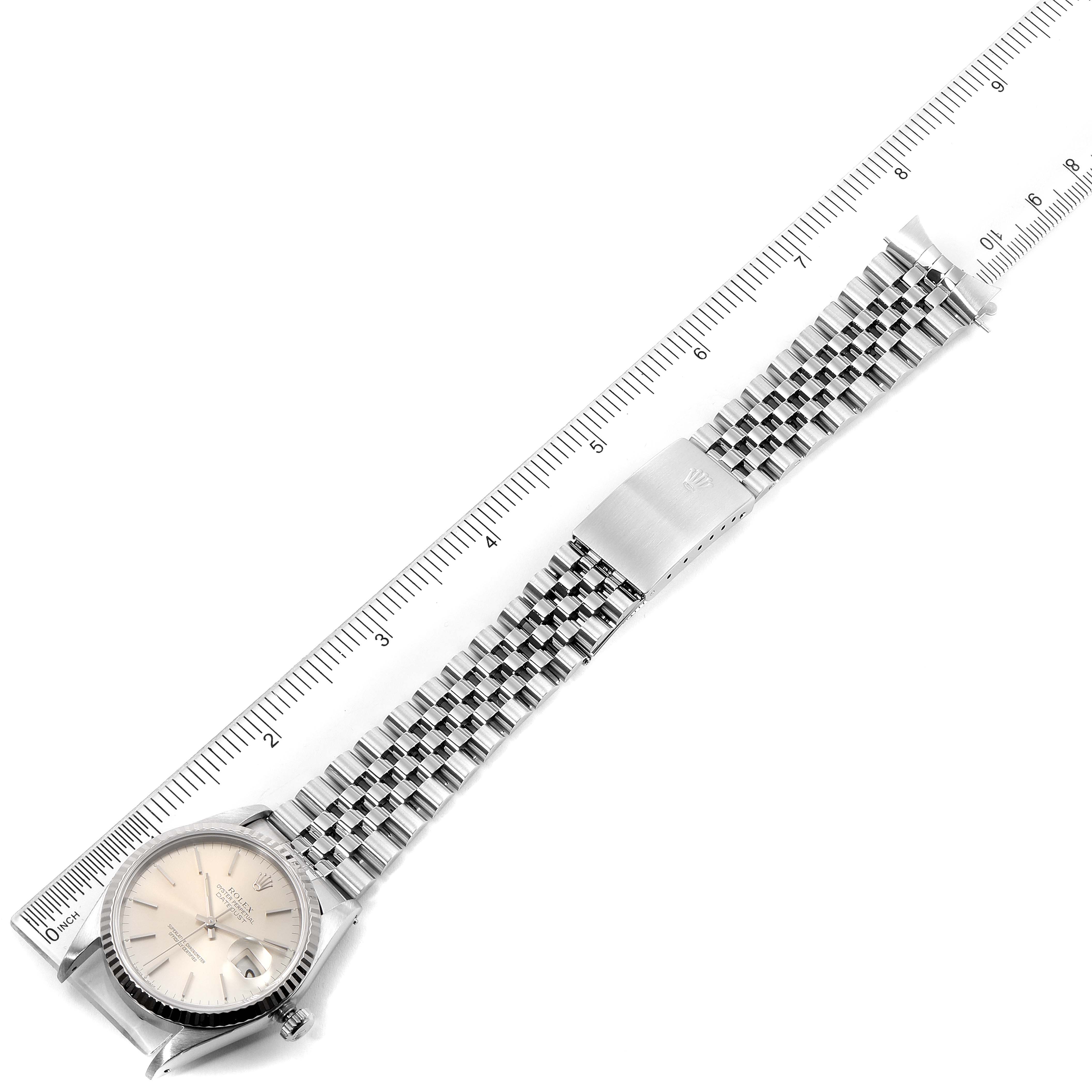 The image shows a laid-flat Rolex Datejust 16234 Men's Stainless Steel Silver Dial 16234 Men's Stainless Steel Silver Dial watch, featuring the face, bezel, and full bracelet aligned with a ruler for scale.