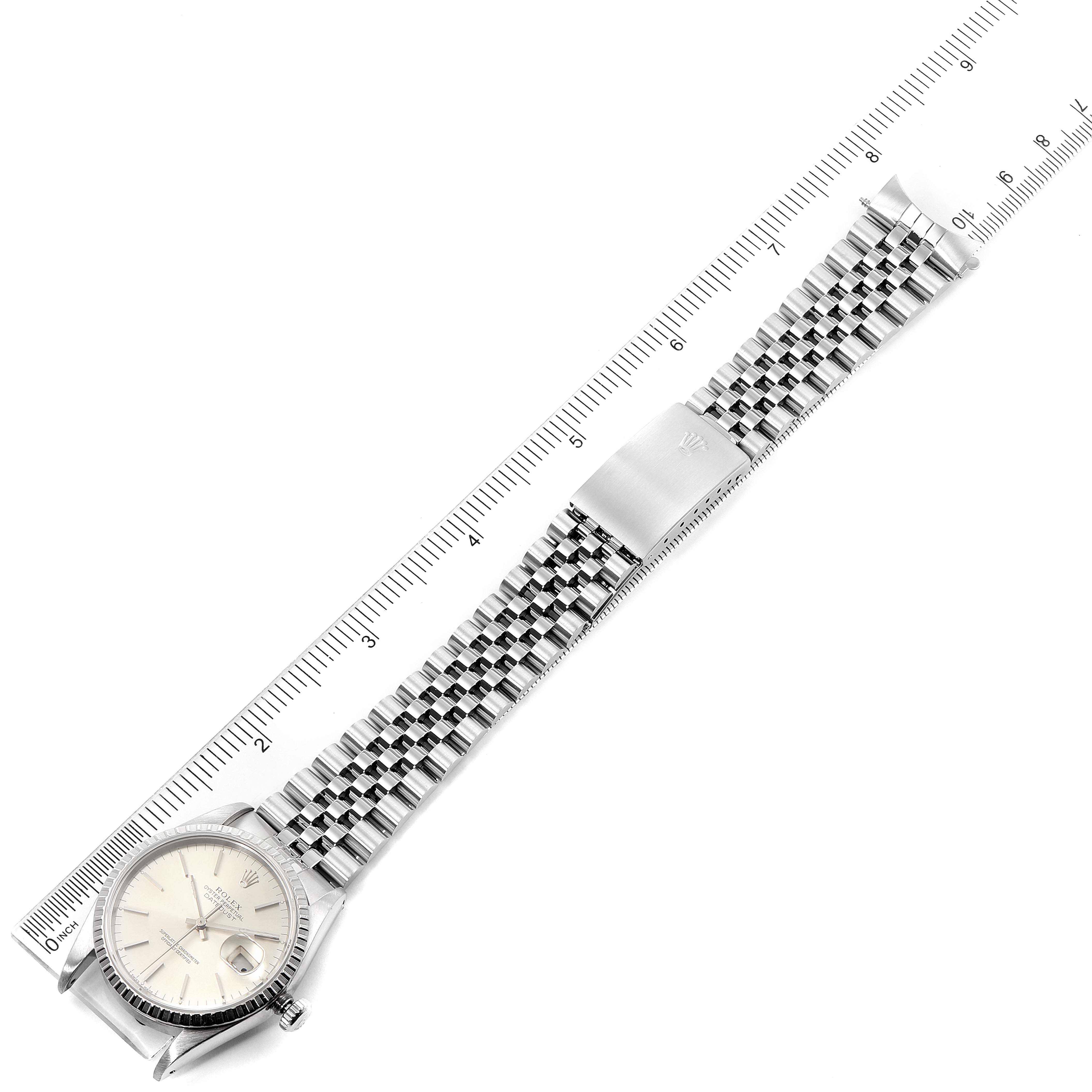 The image shows the Rolex Datejust 16220 Men's Stainless Steel Silver Dial 16220 Men's Stainless Steel Silver Dial watch laid flat with its full bracelet stretched out alongside a ruler for scale.