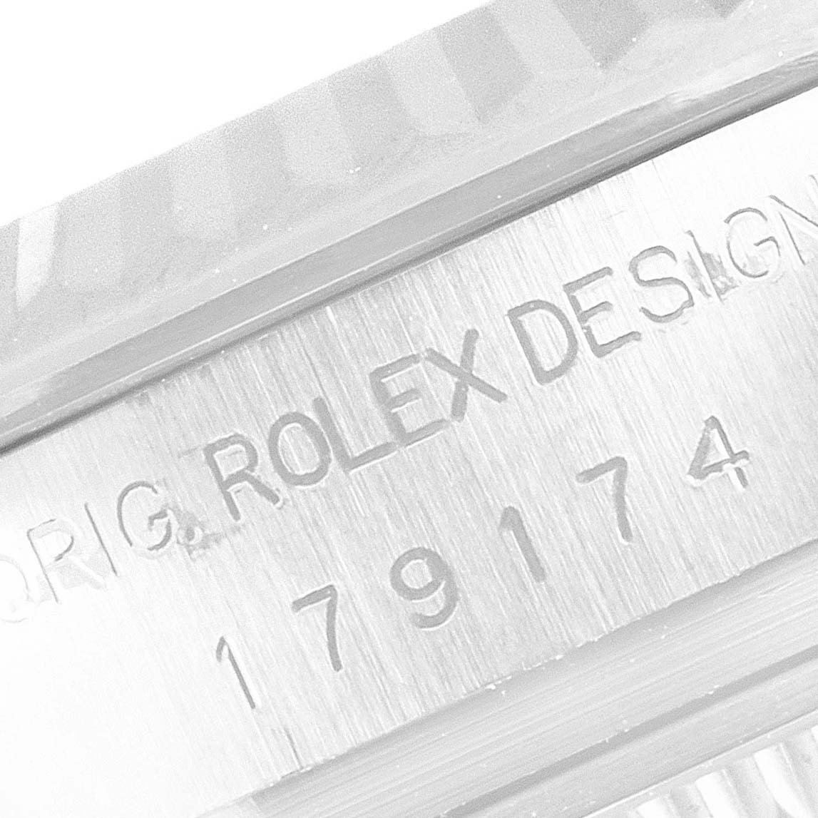 The image shows a macro close-up of the Rolex Datejust 179174 Women
s Stainless Steel Silver Dial 179174 Women
s Stainless Steel Silver Dial watch case, highlighting the engraved "Rolex Design" and model number.