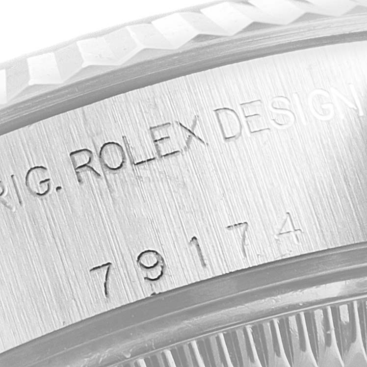 The image shows an extreme close-up of the side engraving on the Rolex Datejust 79174 Women
s Stainless Steel Mother of Pearl Dial 79174 Women
s Stainless Steel Mother of Pearl Dial model, showing serial and model numbers.