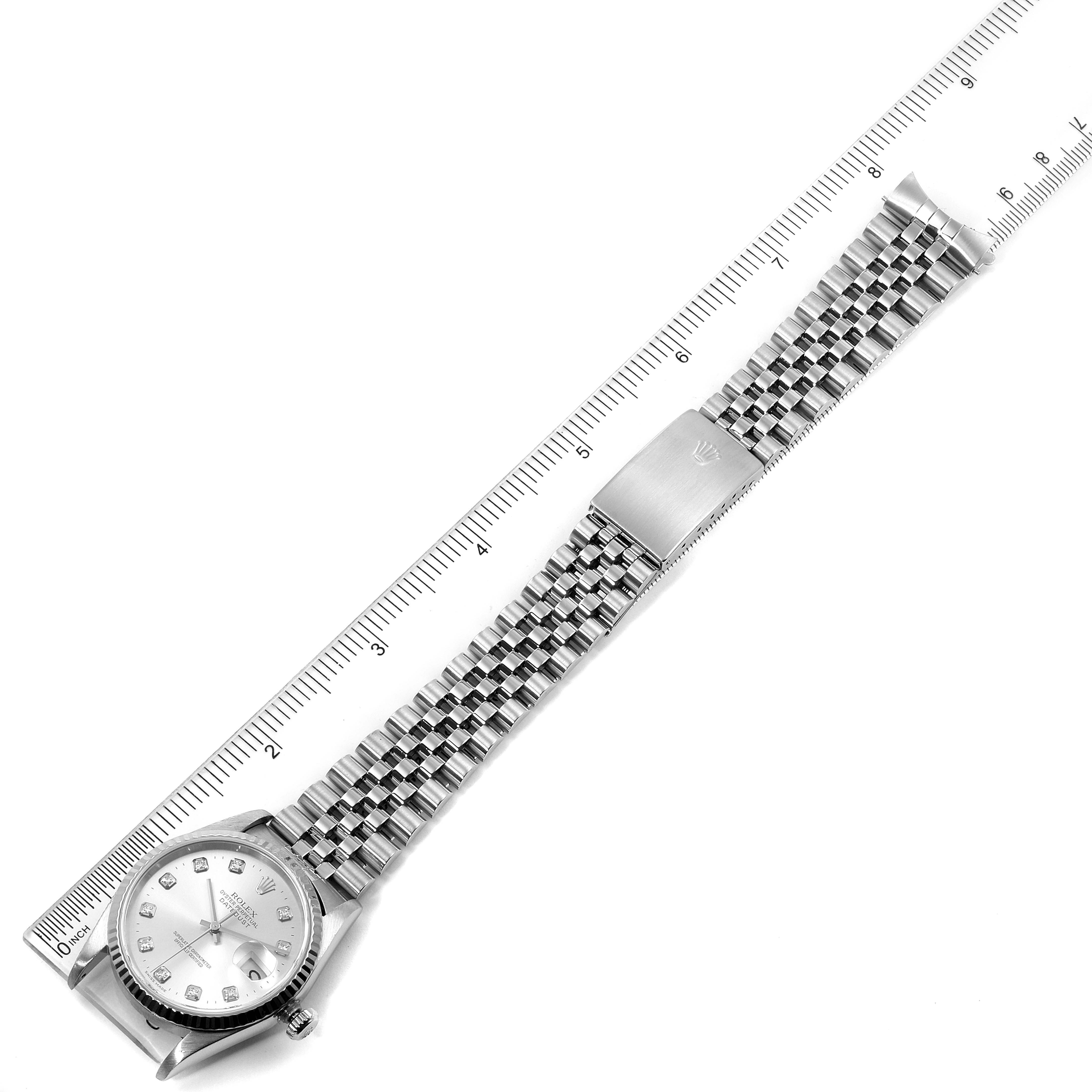 This image shows a top-down view of a Rolex Datejust 16234 Men's Stainless Steel Silver Dial 16234 Men's Stainless Steel Silver Dial watch, including its face, bracelet, and clasp placed next to a ruler.