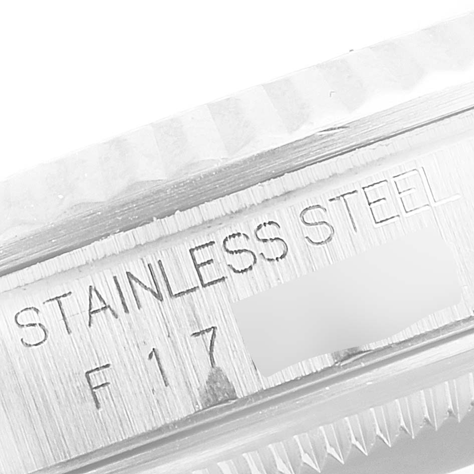 The image shows a macro view of the Rolex Datejust 16234 Men's Stainless Steel Silver Dial 16234 Men's Stainless Steel Silver Dial model's stainless steel case with engravings.