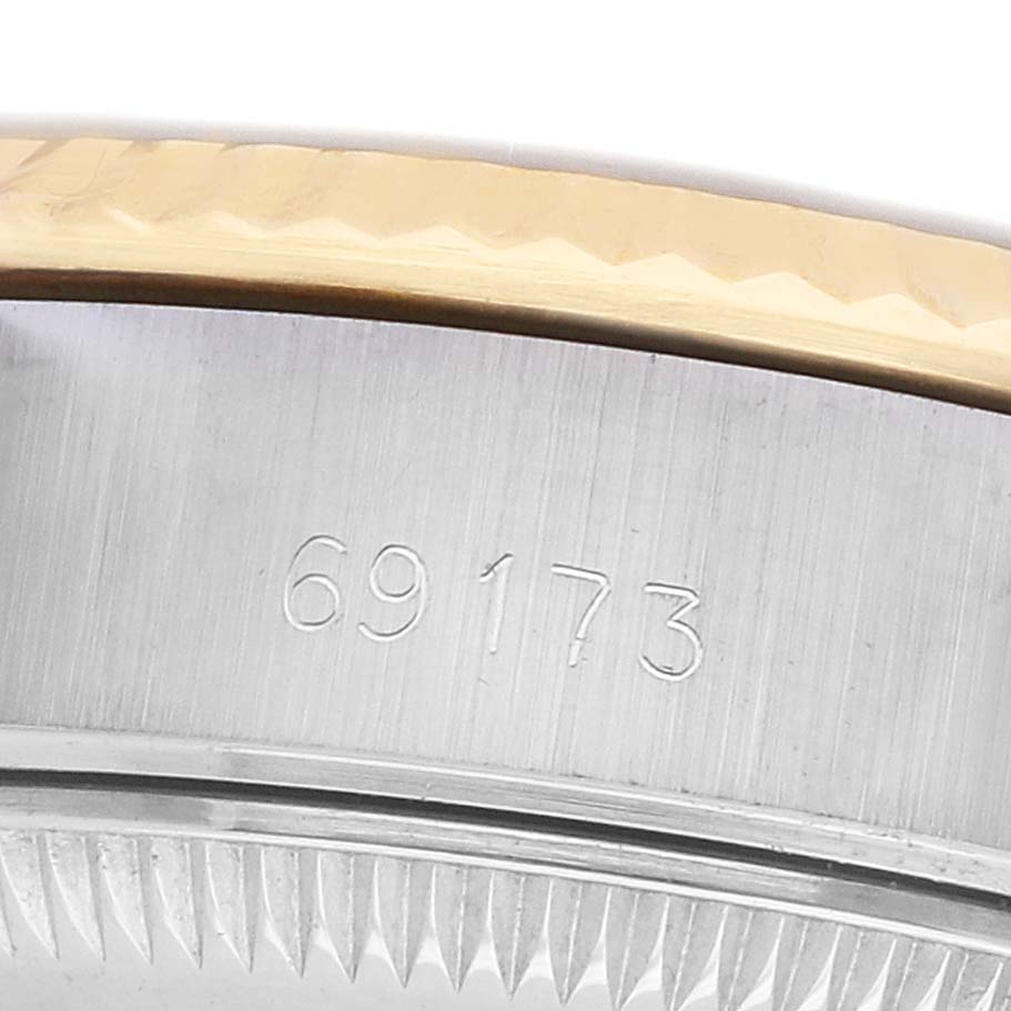 The image shows a close-up of the Rolex Datejust 69173 Women's Steel and Gold (two tone) White Dial's case side and bezel with a visible model number engraving.