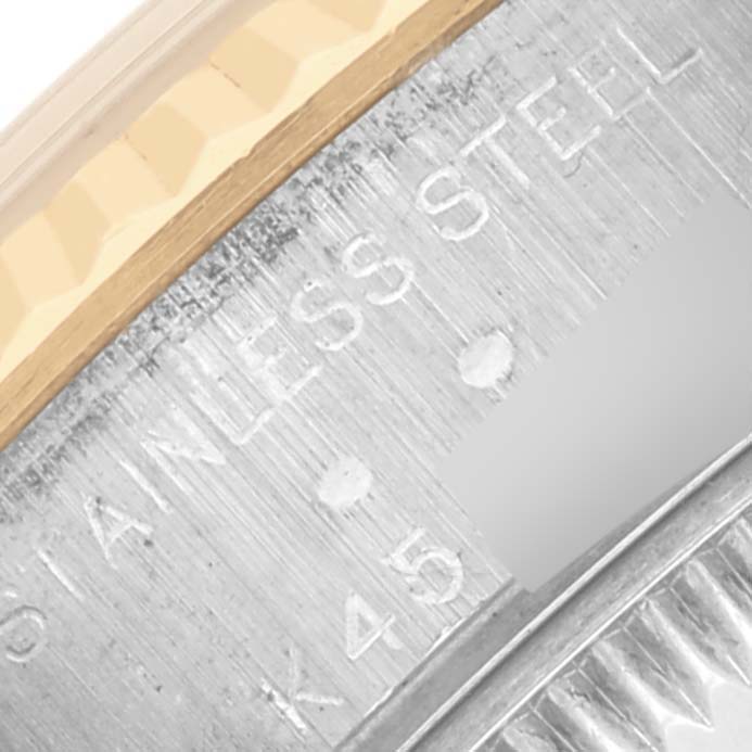 The image shows a close-up of the Rolex Datejust 79173 Women's Steel and Gold (two tone) Blue Dial 79173 Women's Steel and Gold (two tone) Blue Dial watch's bezel and engraved case edge.