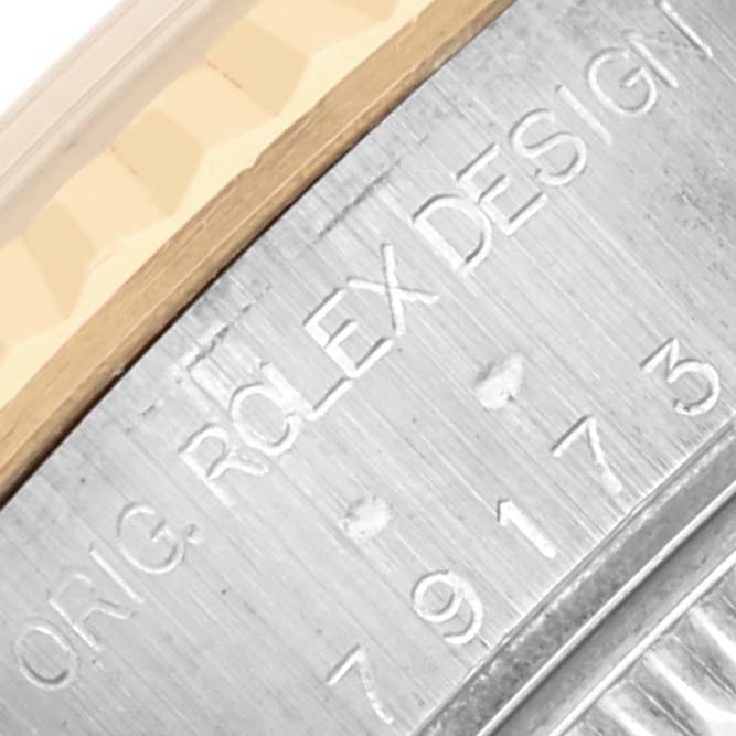 The image shows an angled view of the side with "Rolex Design" and model number engraved on the Rolex Datejust 79173 Women's Steel and Gold (two tone) Blue Dial 79173 Women's Steel and Gold (two tone) Blue Dial.