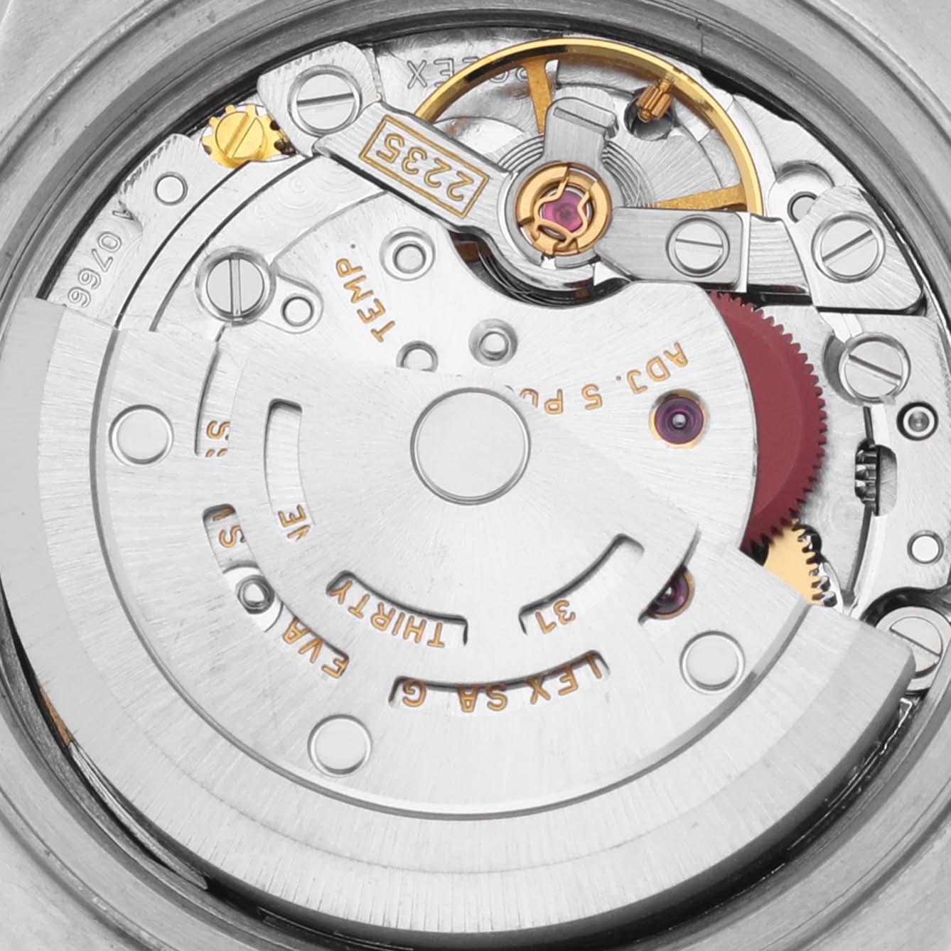 The image shows a close-up of the Rolex Datejust 79173 Women's Steel and Gold (two tone) Blue Dial 79173 Women's Steel and Gold (two tone) Blue Dial's movement, highlighting gears and engravings from a top-down angle.