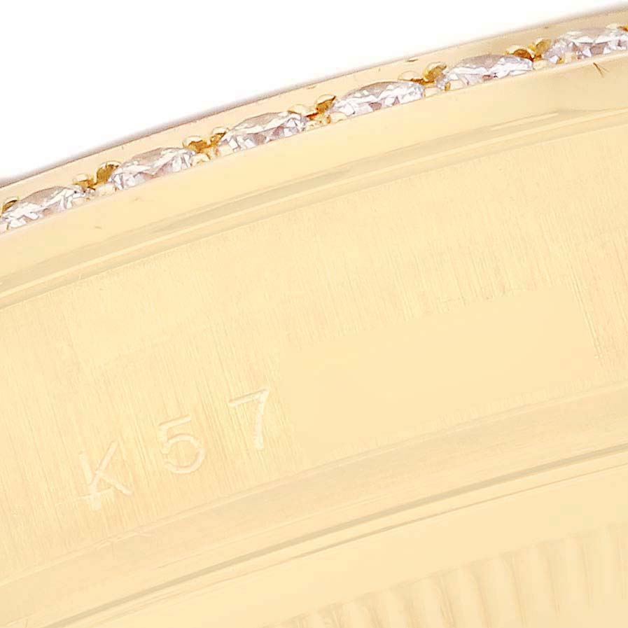 The image shows a close-up of the bezel with diamonds and engraving on the Rolex President 118348 Men
s Yellow Gold Champagne Dial 118348 Men
s Yellow Gold Champagne Dial watch.
