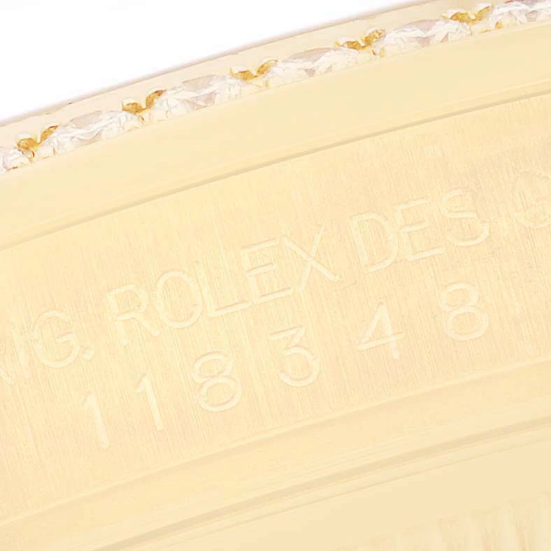 The image shows a close-up view of the Rolex President 118348 Men
s Yellow Gold Champagne Dial 118348 Men
s Yellow Gold Champagne Dial model bezel with engraved details.