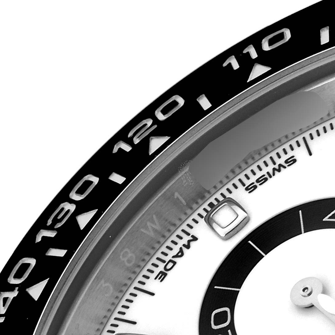 The image shows a close-up of the bezel and part of the dial of a Rolex Daytona 116500LN Men's Stainless Steel White Dial 116500LN Men's Stainless Steel White Dial watch.