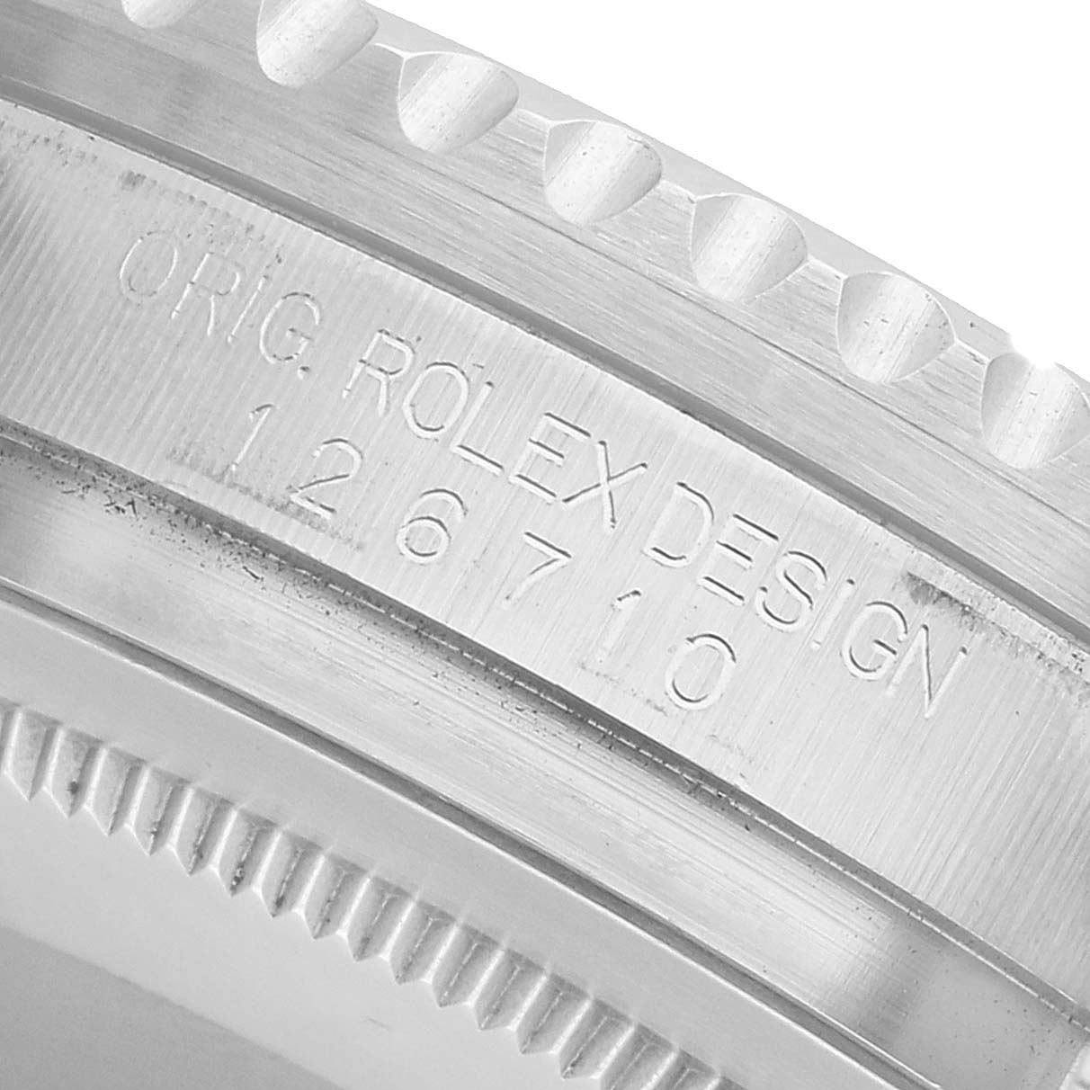 The image shows a close-up of the Rolex GMT-Master 126710BLNR Men's Stainless Steel Black Dial model's engraved case side, featuring text and the model number 126710.
