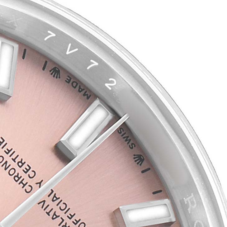 The image shows a close-up of the Rolex Oyster Perpetual 276200 Women's Stainless Steel Pink Dial's dial edge and part of its hour markers and bezel.