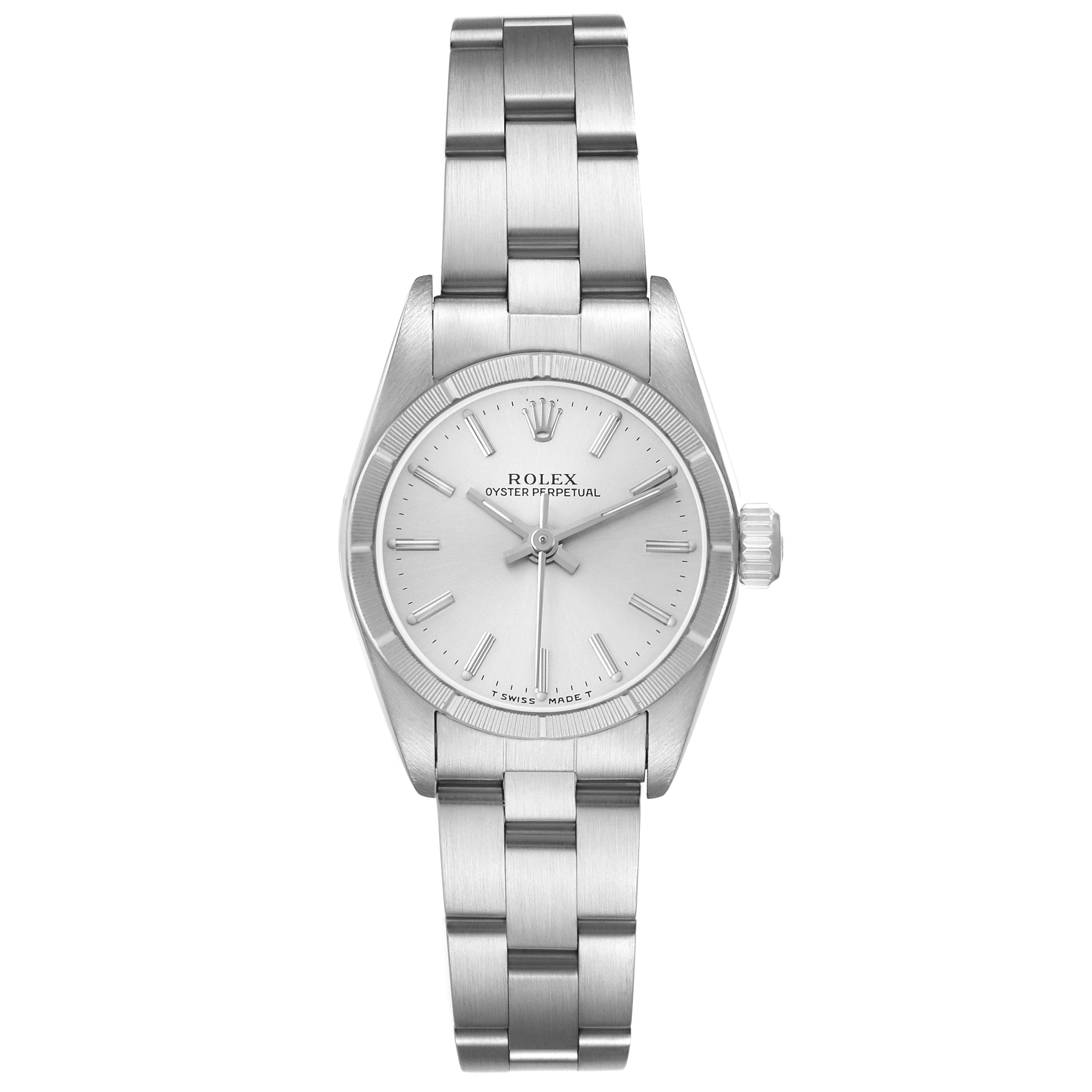 The Rolex Oyster Perpetual 67230 Women's Stainless Steel Silver Dial watch is shown from a top-down angle, displaying the full face, bracelet, and crown.