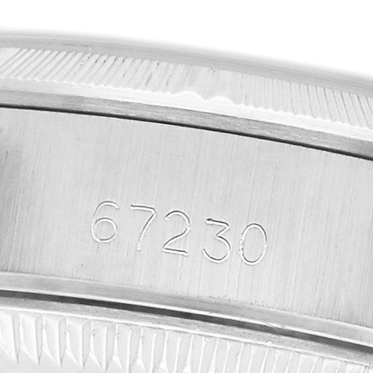 The image shows a close-up of the bezel and part of the case with the engraved reference number "67230" on a Rolex Oyster Perpetual 67230 Women's Stainless Steel Silver Dial.