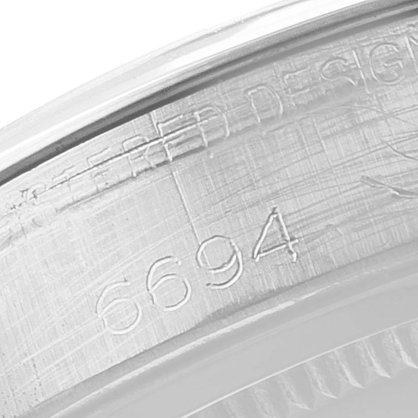 This is a close-up of the caseback engraving on a Vintage Collection model by Rolex, showing the serial number and part of the model details.