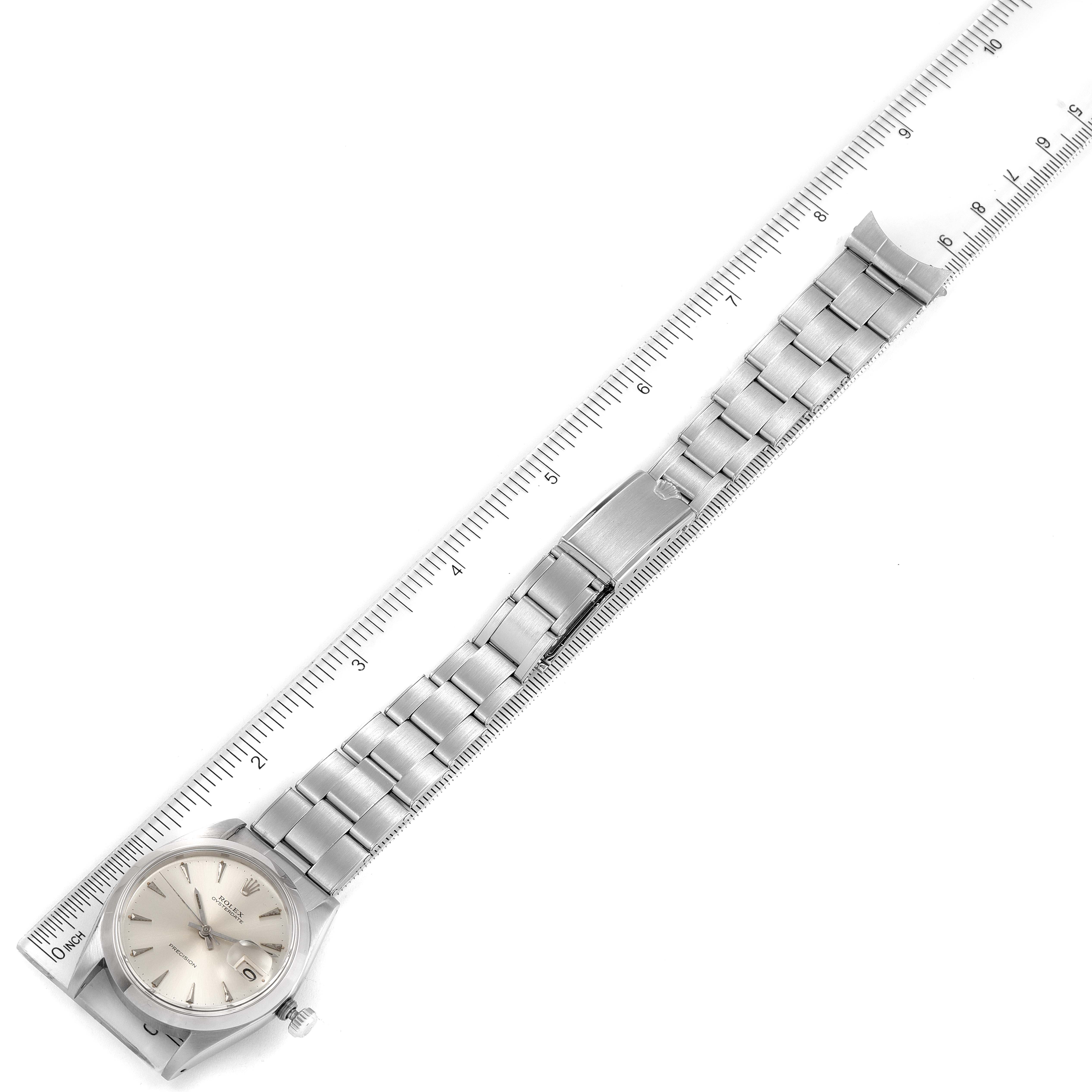 The image shows a top-down view of a Rolex Vintage Collection 6694 Men's Stainless Steel Silver Dial 6694 Men's Stainless Steel Silver Dial watch with its entire band, placed alongside a ruler.