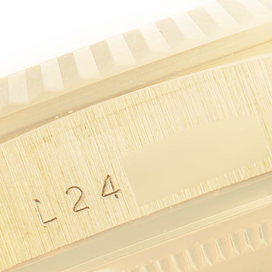 The image shows a close-up of the bezel and serial number of a Rolex President 18238 Men
s Yellow Gold Champagne Dial 18238 Men
s Yellow Gold Champagne Dial model watch.