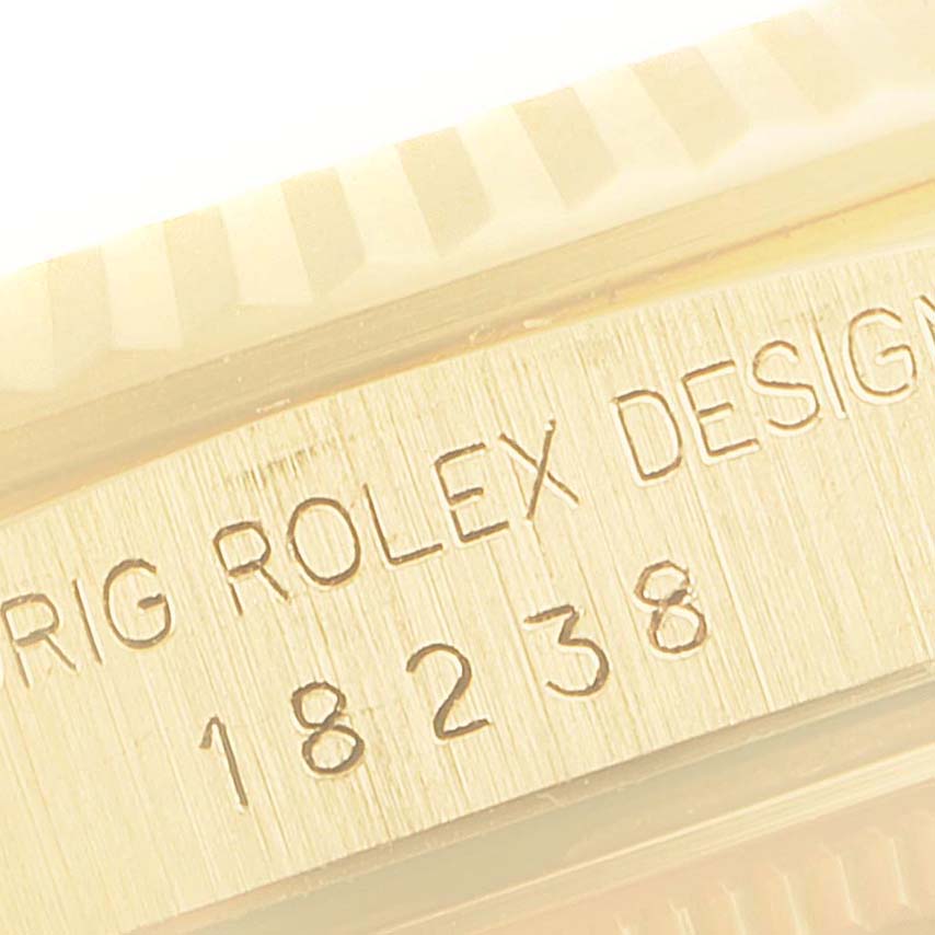 The image shows a close-up of the engraved text and model number on the side of a Rolex President 18238 Men
s Yellow Gold Champagne Dial 18238 Men
s Yellow Gold Champagne Dial watch.