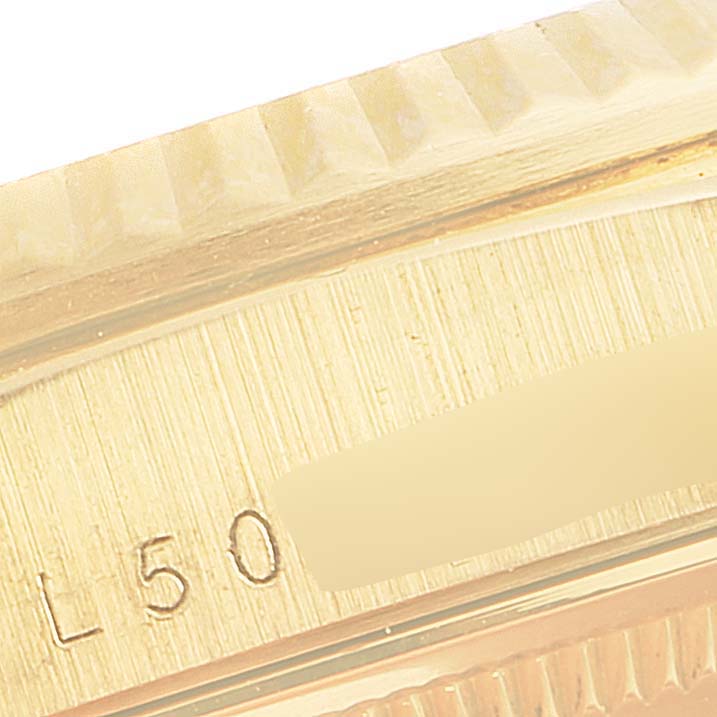 This close-up image shows the side view of the gold fluted bezel and part of the case of a Rolex President 18238 Men
s Yellow Gold Champagne Dial 18238 Men
s Yellow Gold Champagne Dial model watch.