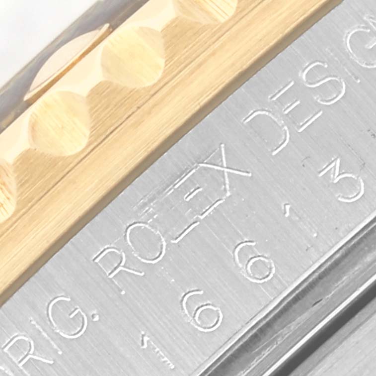 The image shows a close-up view of the engraving on the Rolex Submariner 16613 Men's Steel and Gold (two tone) Blue Dial 16613 Men's Steel and Gold (two tone) Blue Dial's bezel and case side.