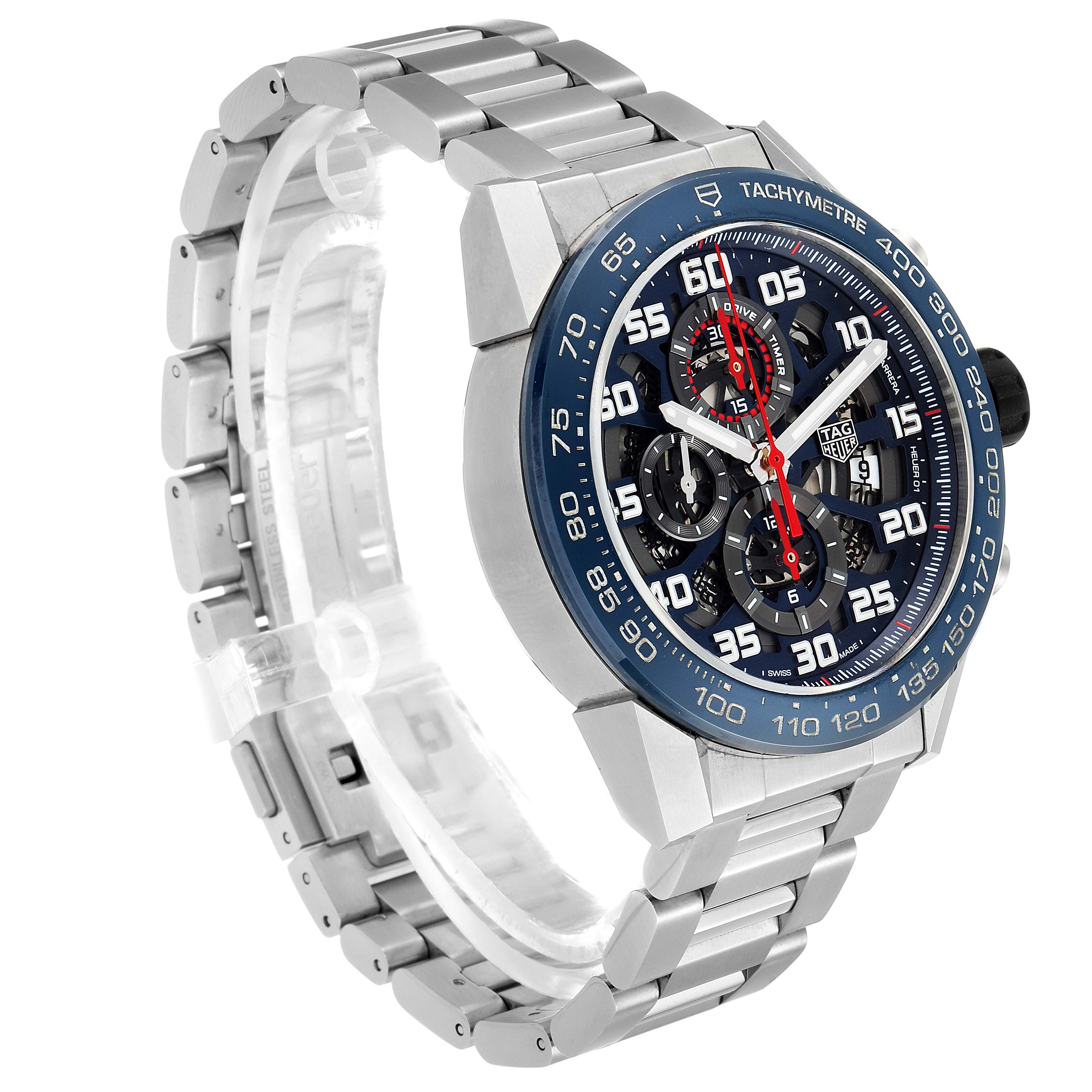 The image shows a Tag Heuer Carrera CAR2A1K.BA0703 Men
s Stainless Steel Blue Dial CAR2A1K.BA0703 Men
s Stainless Steel Blue Dial watch from an angled perspective highlighting its face, bezel, and bracelet.