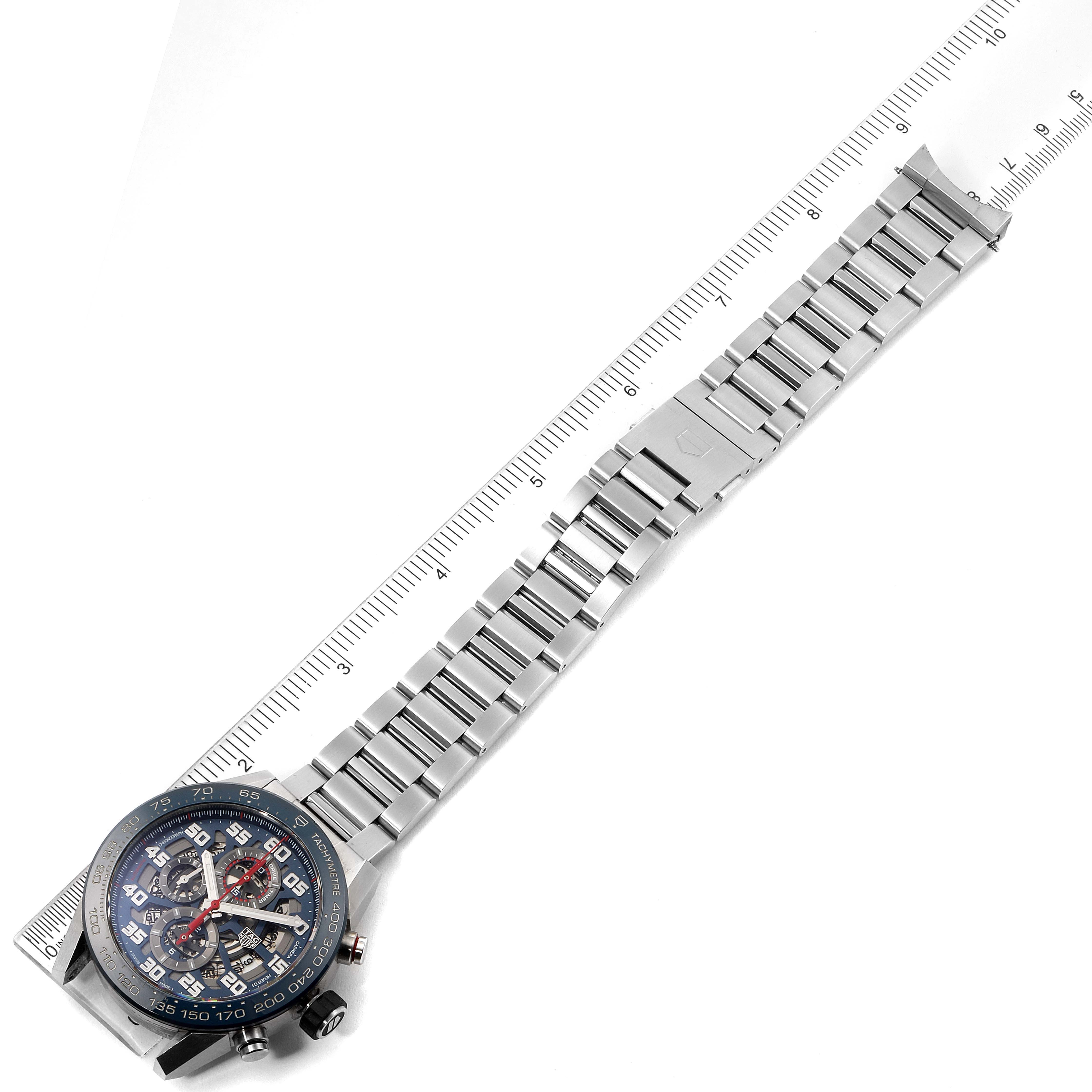 The image shows a Tag Heuer Carrera CAR2A1K.BA0703 Men
s Stainless Steel Blue Dial CAR2A1K.BA0703 Men
s Stainless Steel Blue Dial watch positioned horizontally with an extended metal bracelet and a ruler for scale.