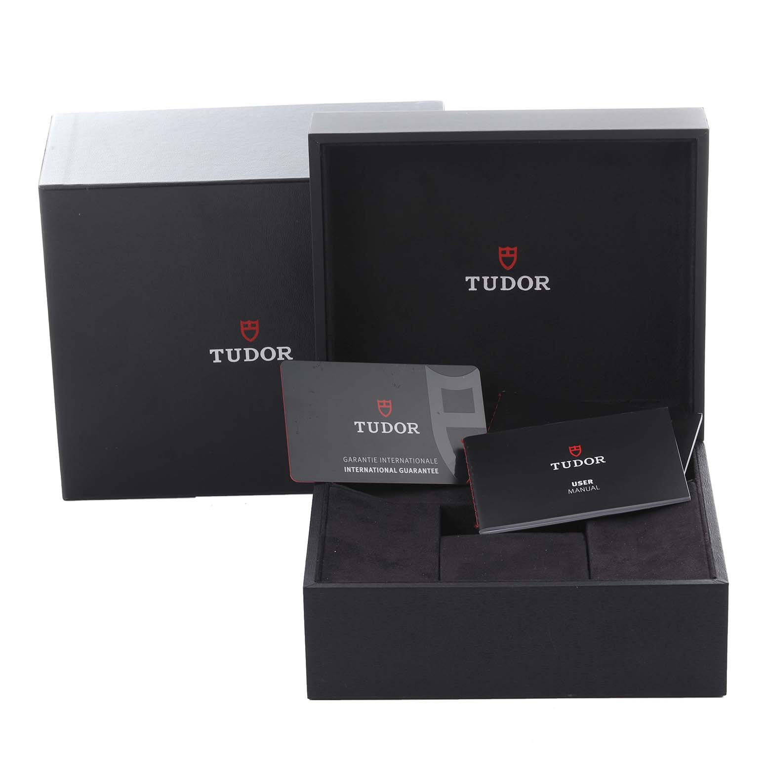 The image shows the Heritage Chrono by Tudor packaging, guarantee card, and user manual from the front angle.