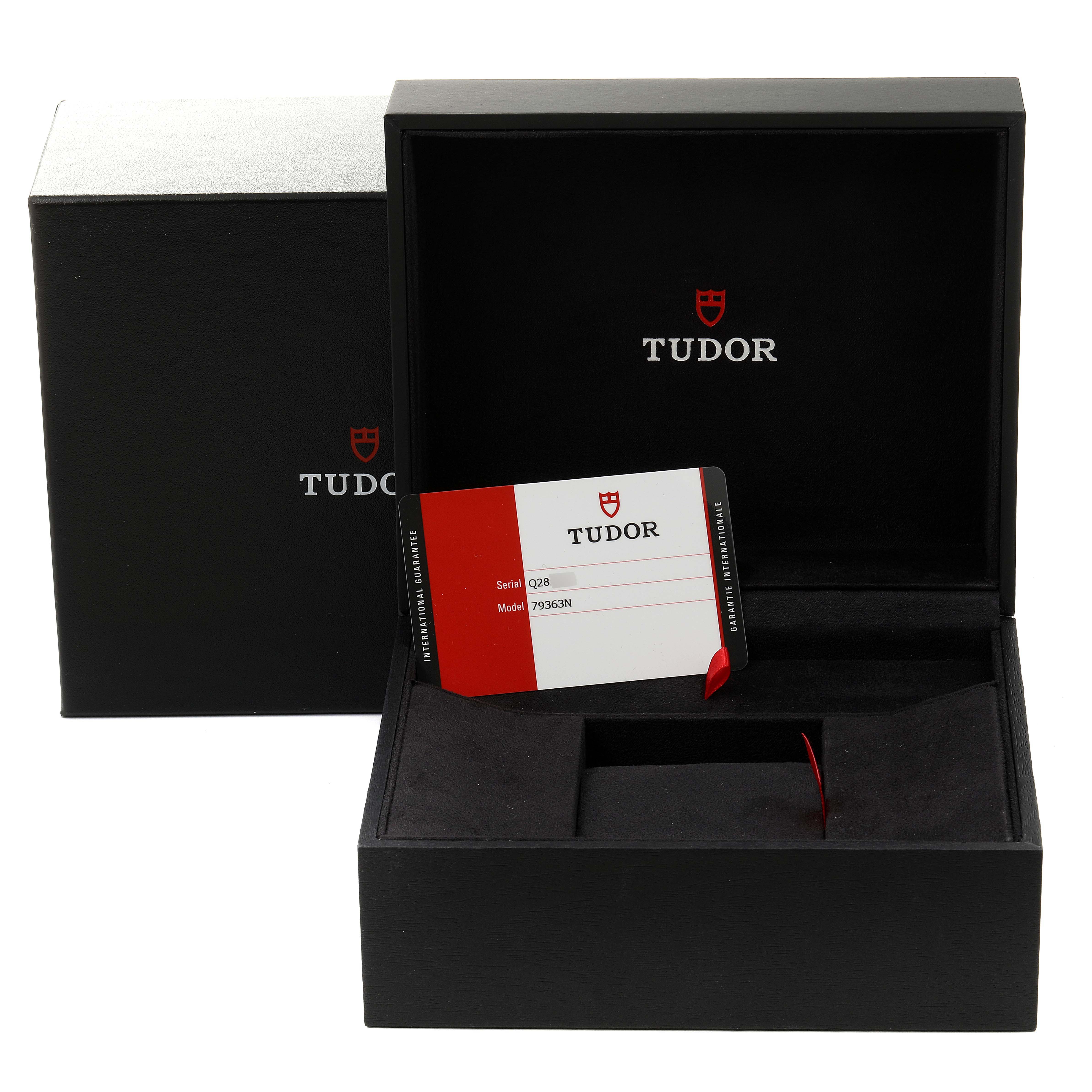 The image shows the open packaging box and warranty card for the Tudor Heritage Black Bay 79363N Men's Steel and Gold (two tone) Black Dial 79363N Men's Steel and Gold (two tone) Black Dial watch.