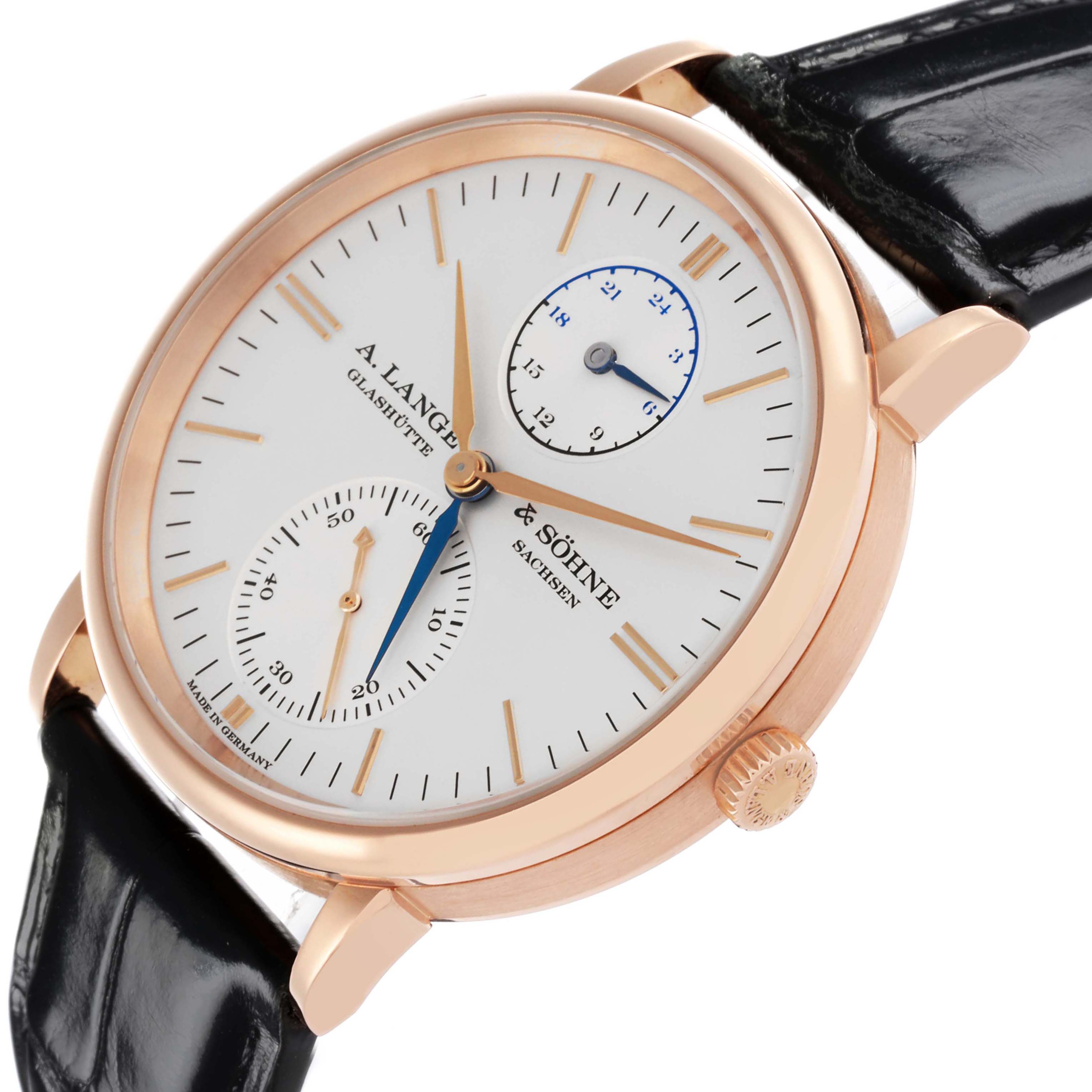 The image shows a Saxonia model by A. Lange & Söhne at a slight angle, displaying its dial, crown, and black leather strap.