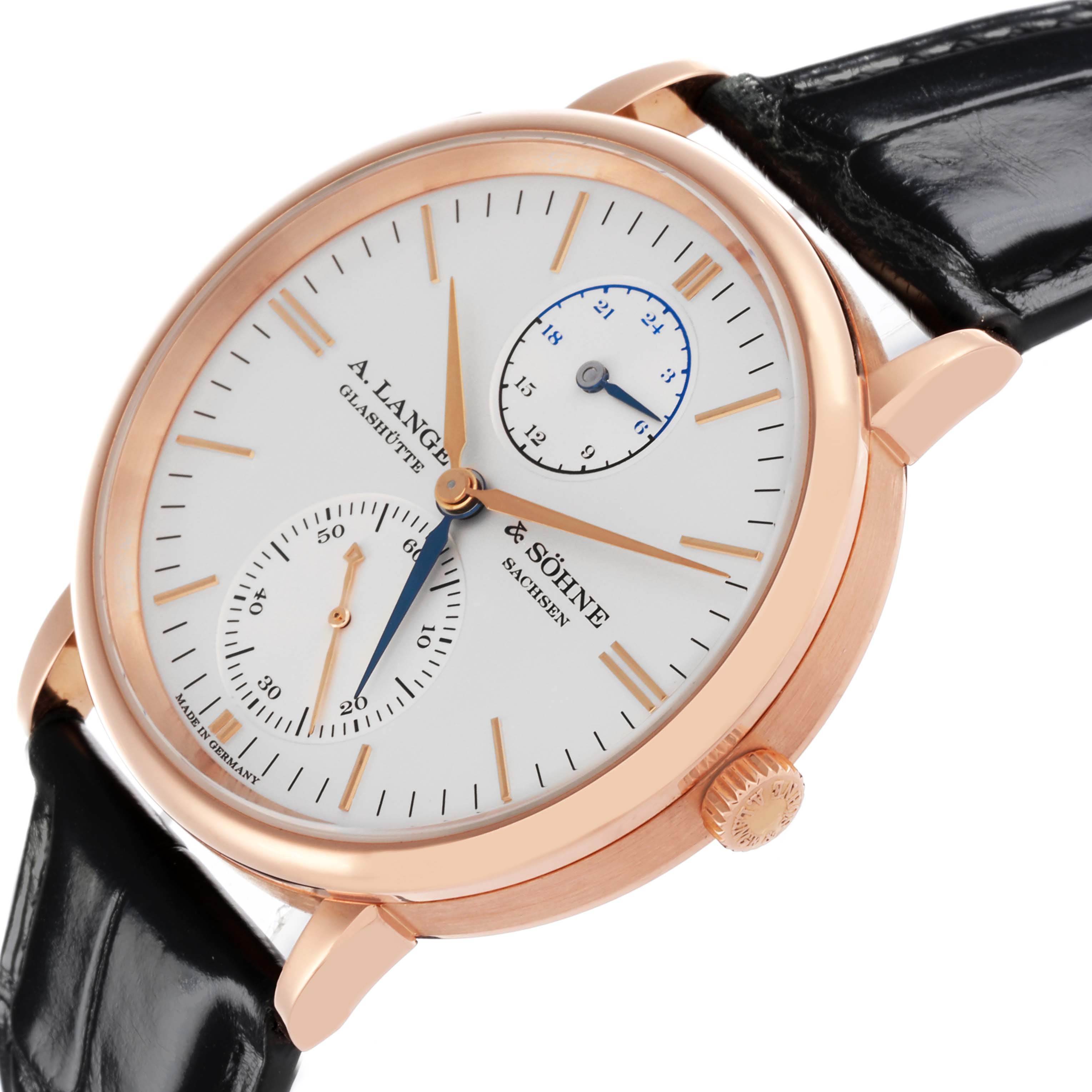 The watch is shown at a three-quarter angle, highlighting the Saxonia model by A. Lange & Söhne, including the face, crown, and strap.