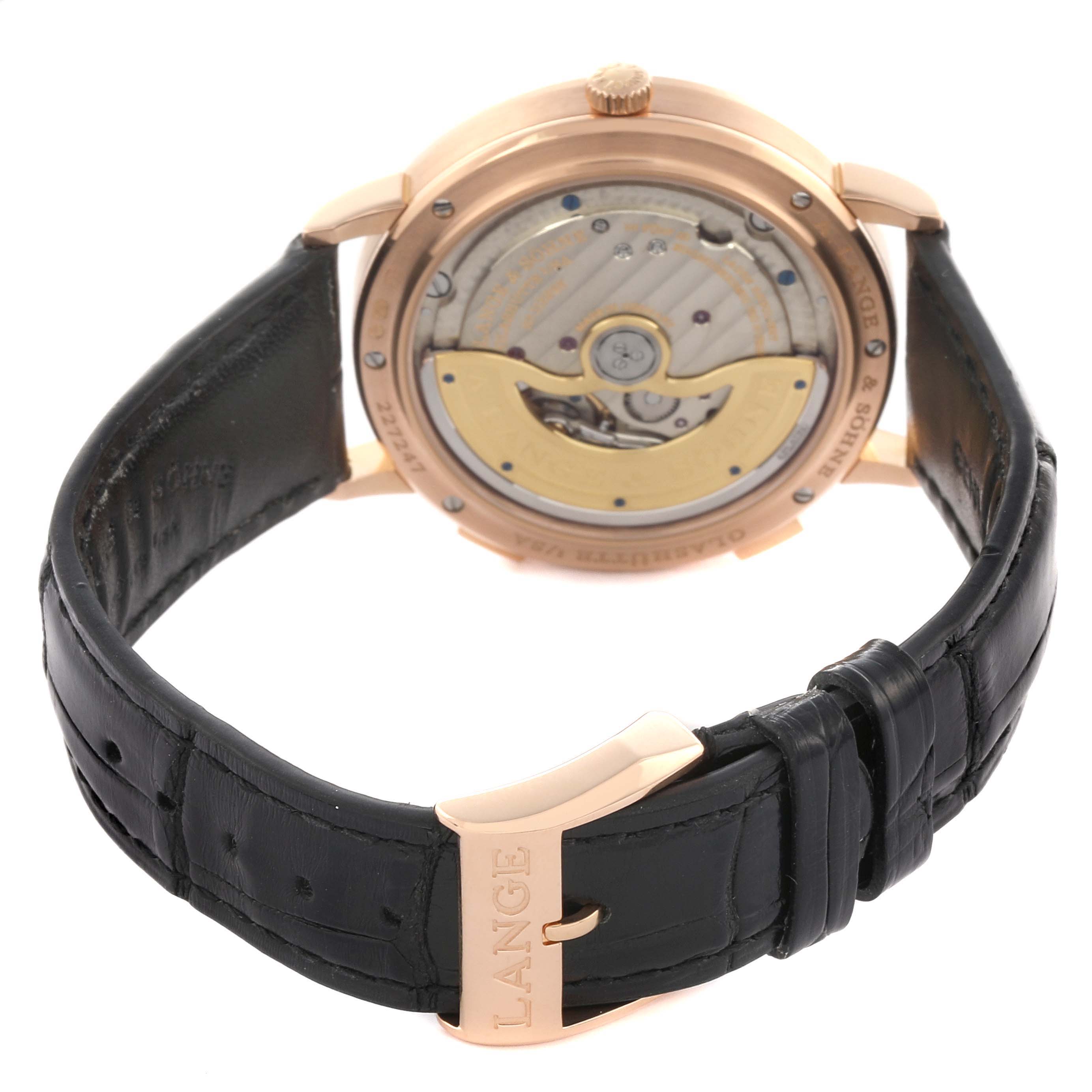 The image shows the reverse side of the Saxonia watch by A. Lange & Söhne, highlighting the movement and leather strap.