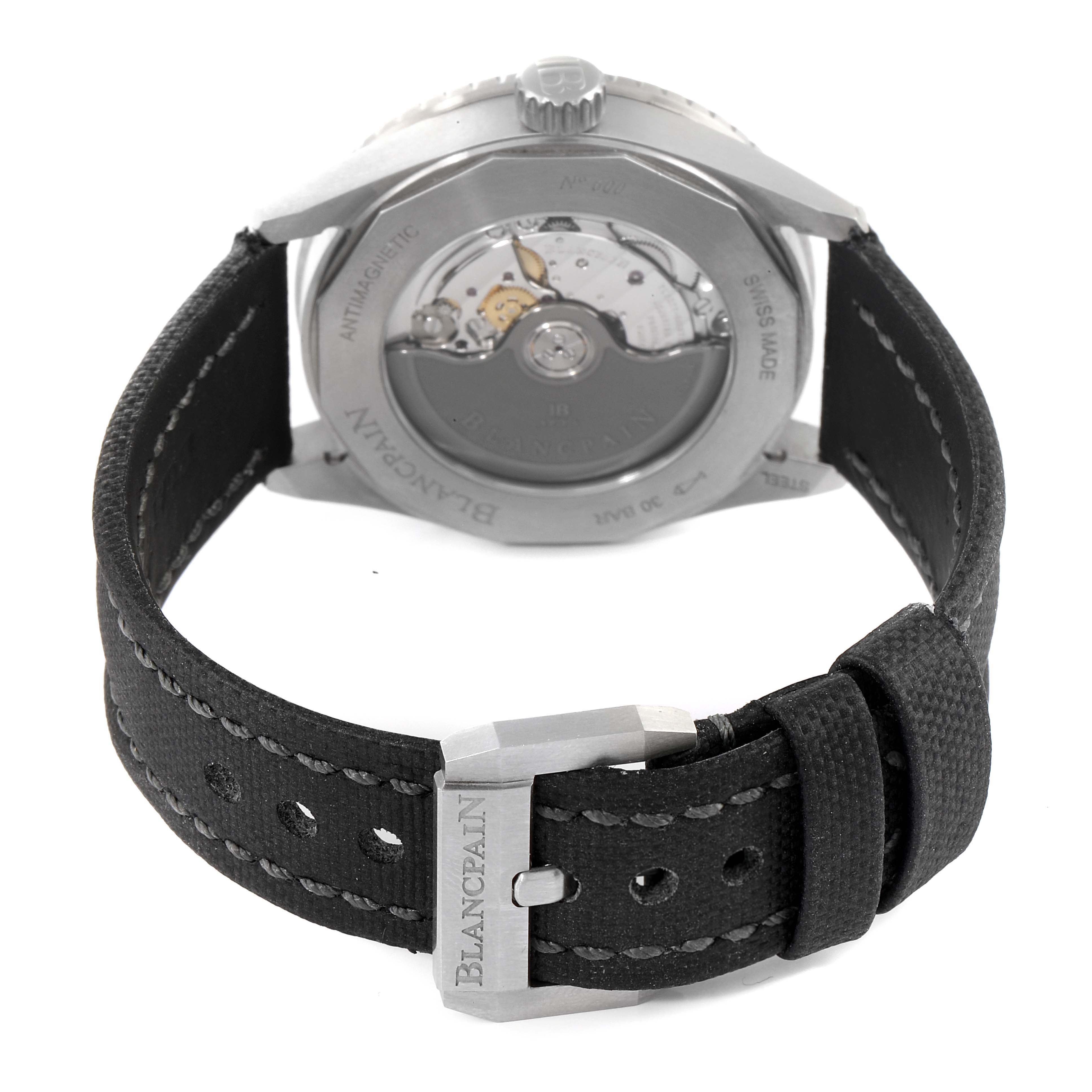 The image shows the back view of a Blancpain Fifty Fathoms 5100B-1110-B52A Men's Stainless Steel Grey Dial 5100B-1110-B52A Men's Stainless Steel Grey Dial watch, highlighting the movement mechanism and a partially open strap with a branded buckle.