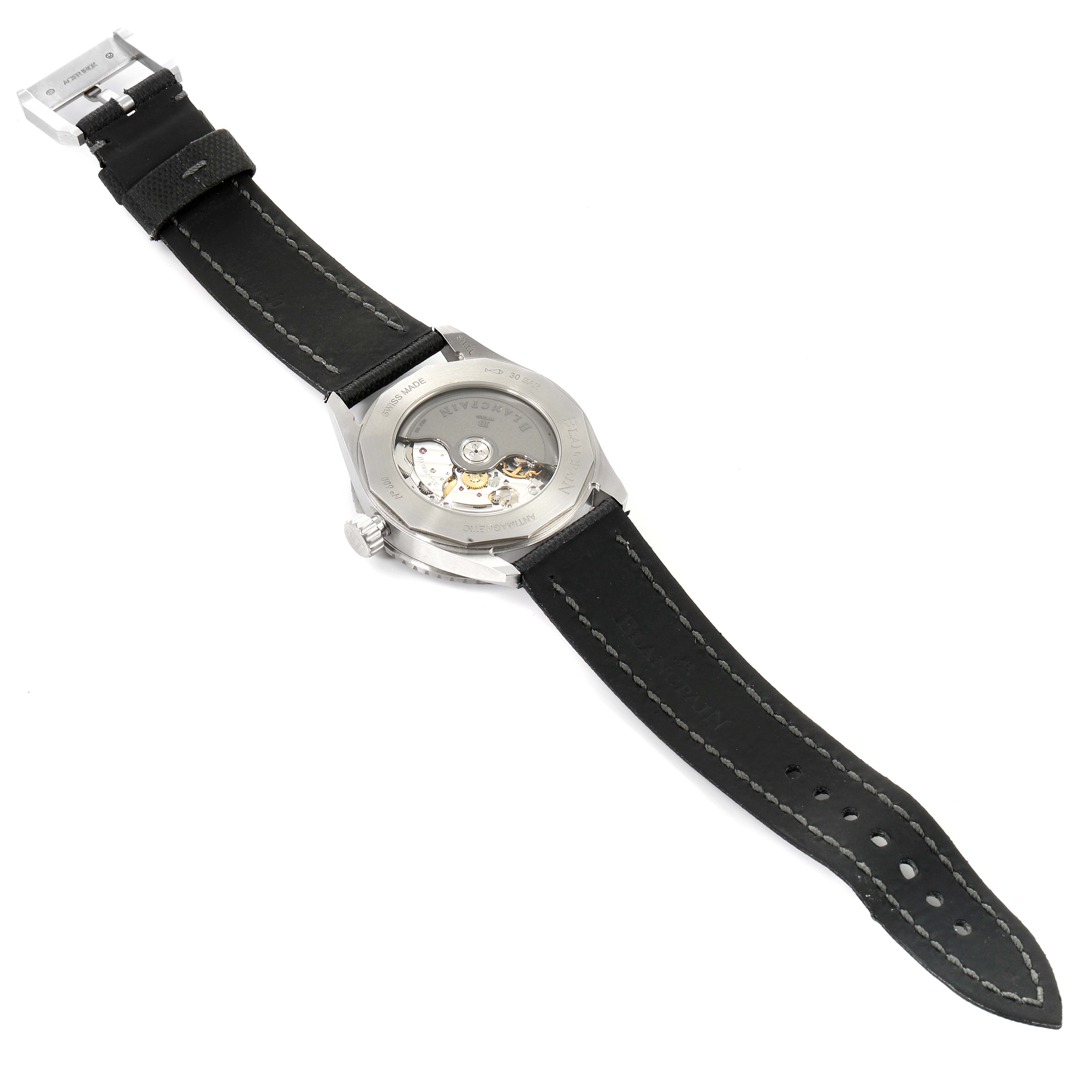 The image shows the back view of the Fifty Fathoms model by Blancpain, displaying the open case back and the movement inside.