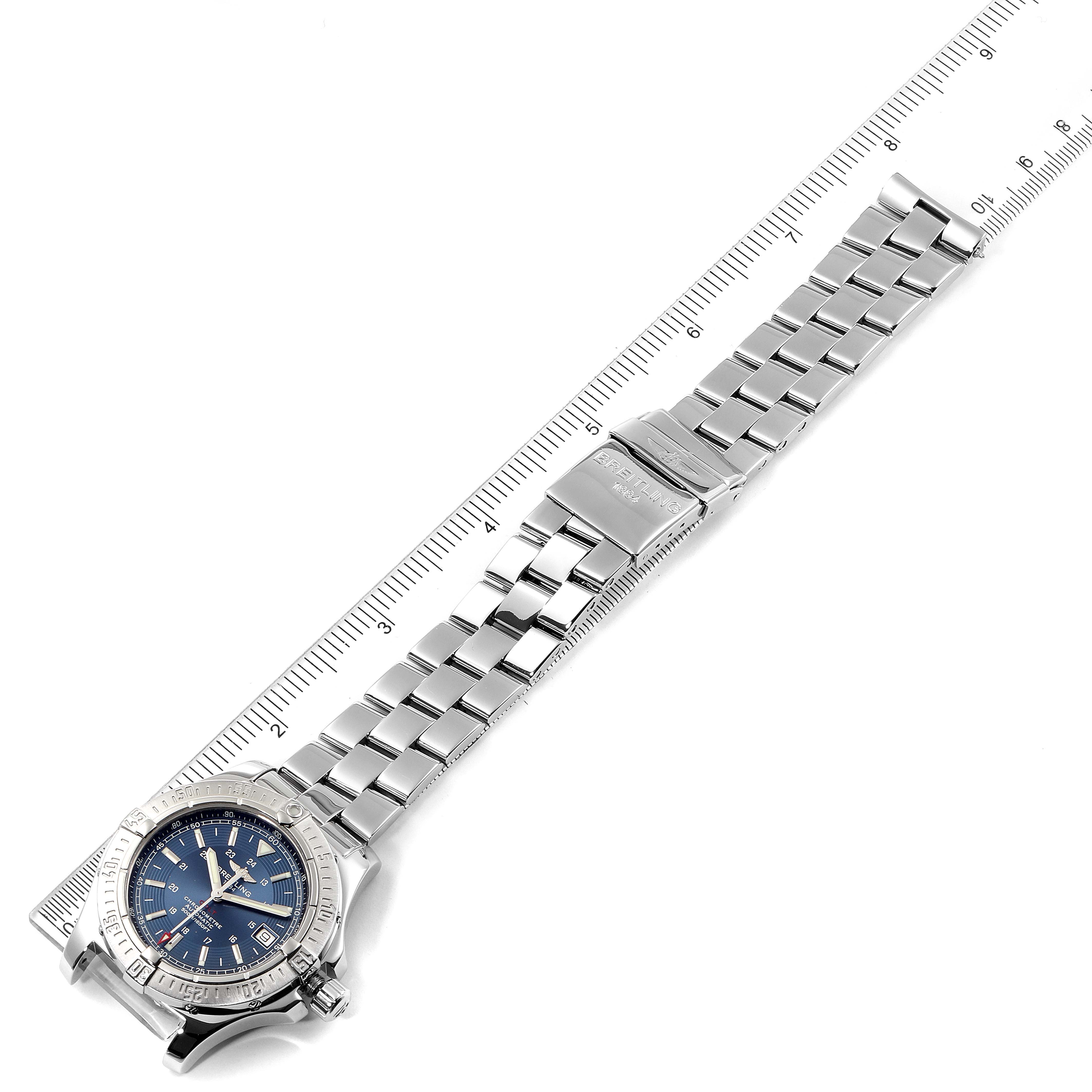 The image shows a Breitling Colt A17380 Men's Stainless Steel Blue Dial A17380 Men's Stainless Steel Blue Dial model watch angled diagonally with a focus on its metal bracelet and clasp, adjacent to a measuring ruler.
